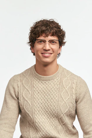 Smiling man wearing glasses and a sweater.