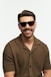 A smiling man is wearing sunglasses.