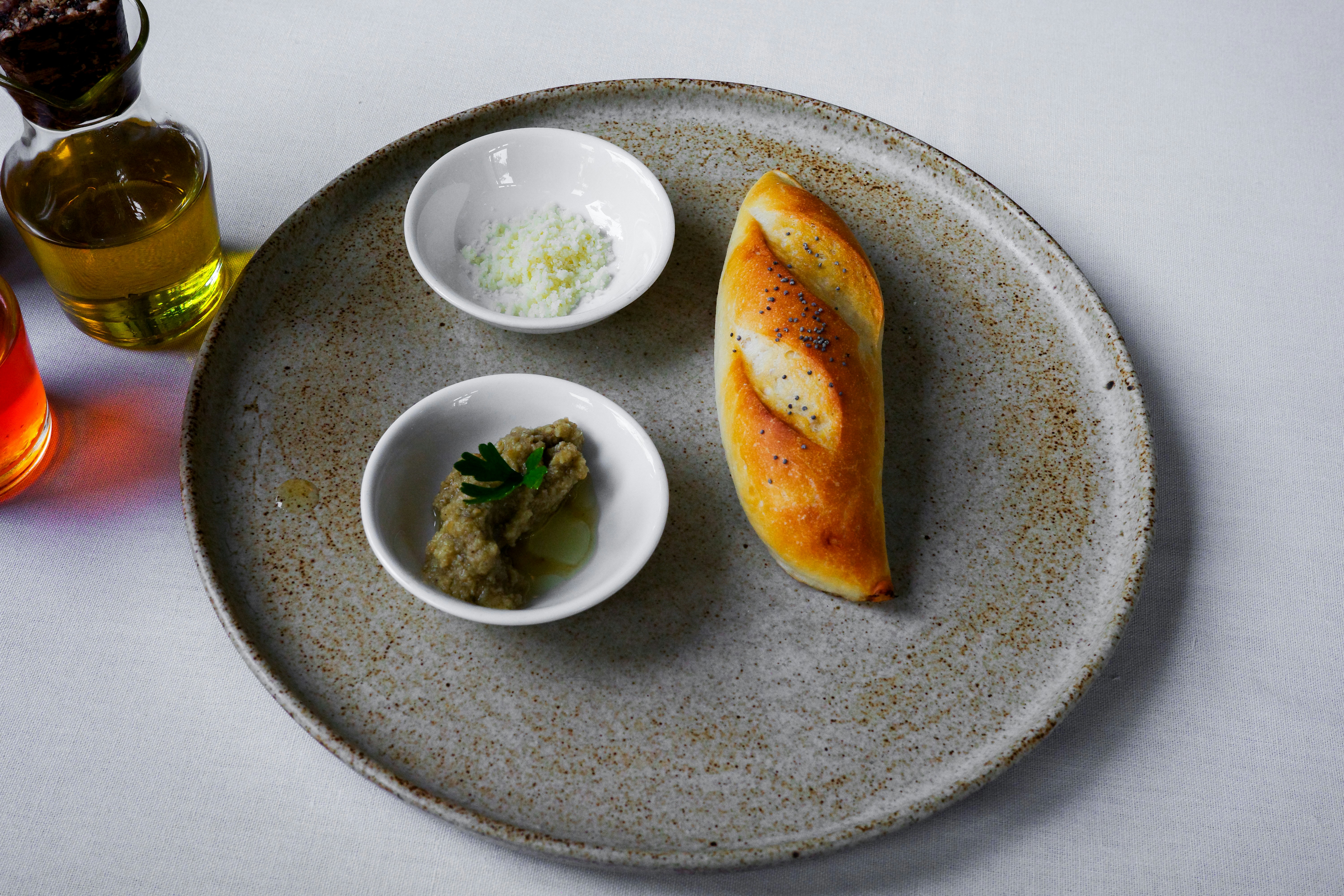 Bread, dips, and oil are displayed on a plate - Free Photo on Unsplash