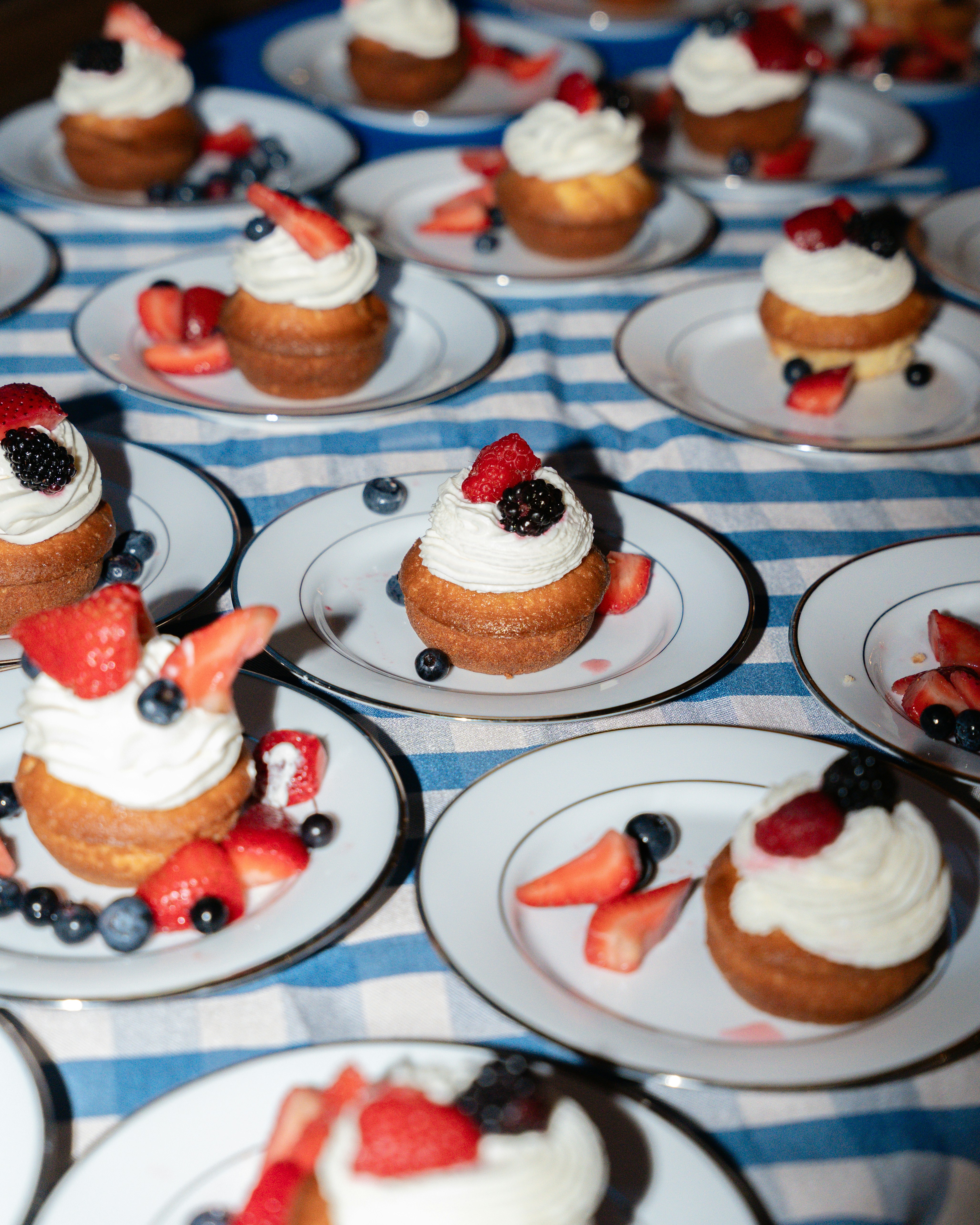 Cupcakes are ready, topped with berries and cream.