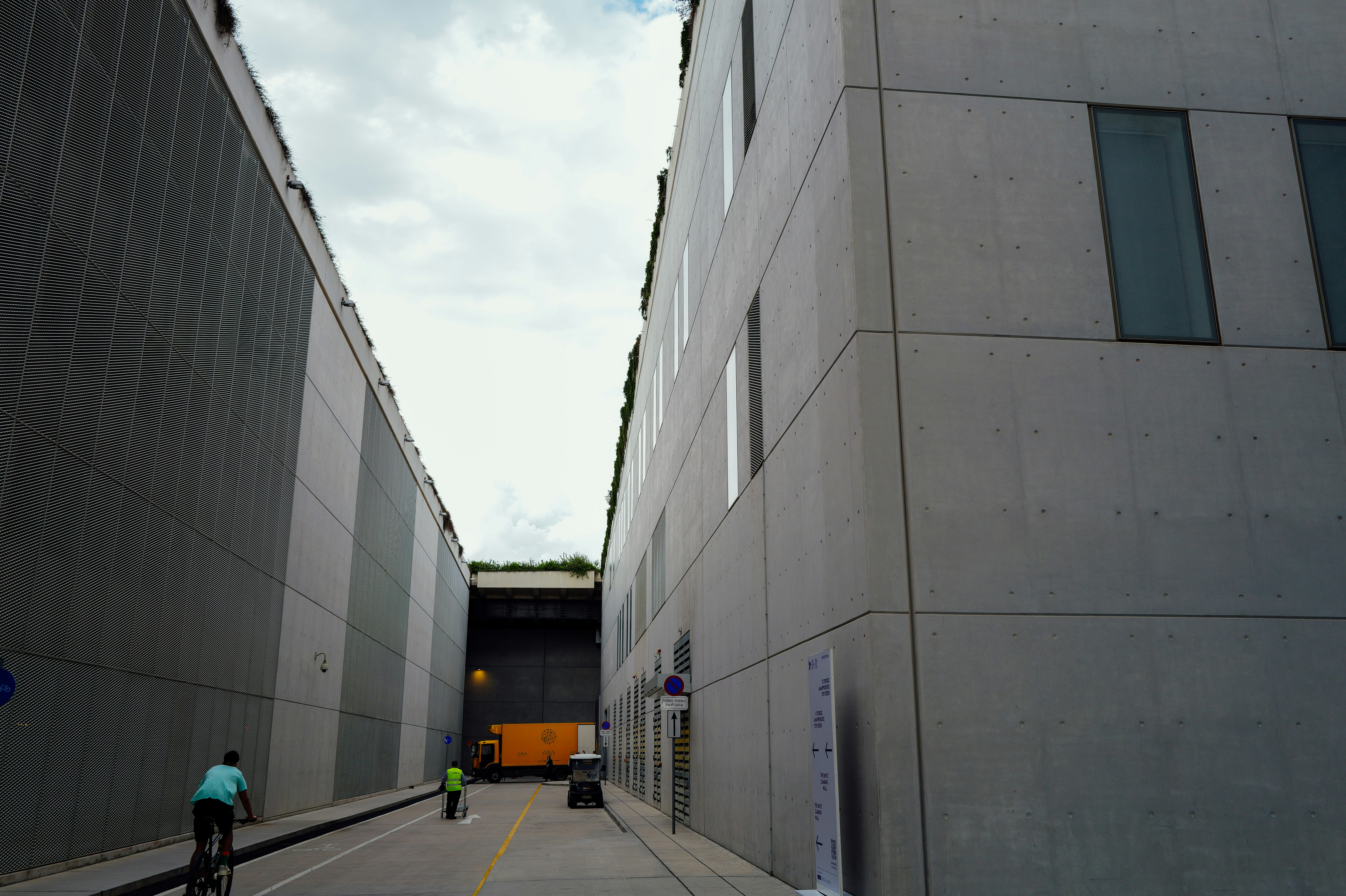 Buildings flank a street with cyclists and pedestrians.