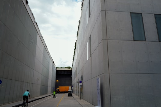 Buildings flank a street with cyclists and pedestrians.