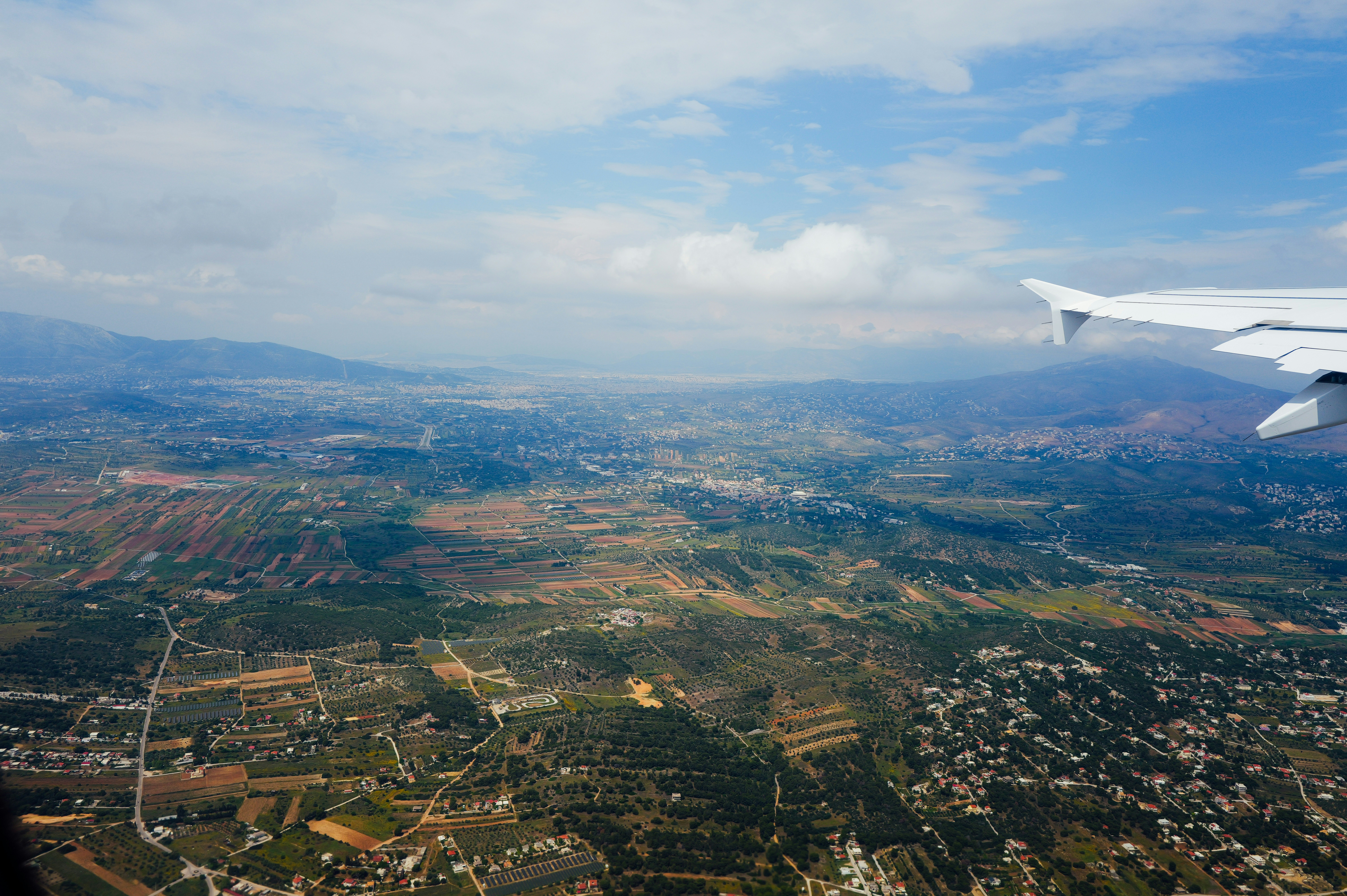 Aerial view of a landscape with an airplane wing.