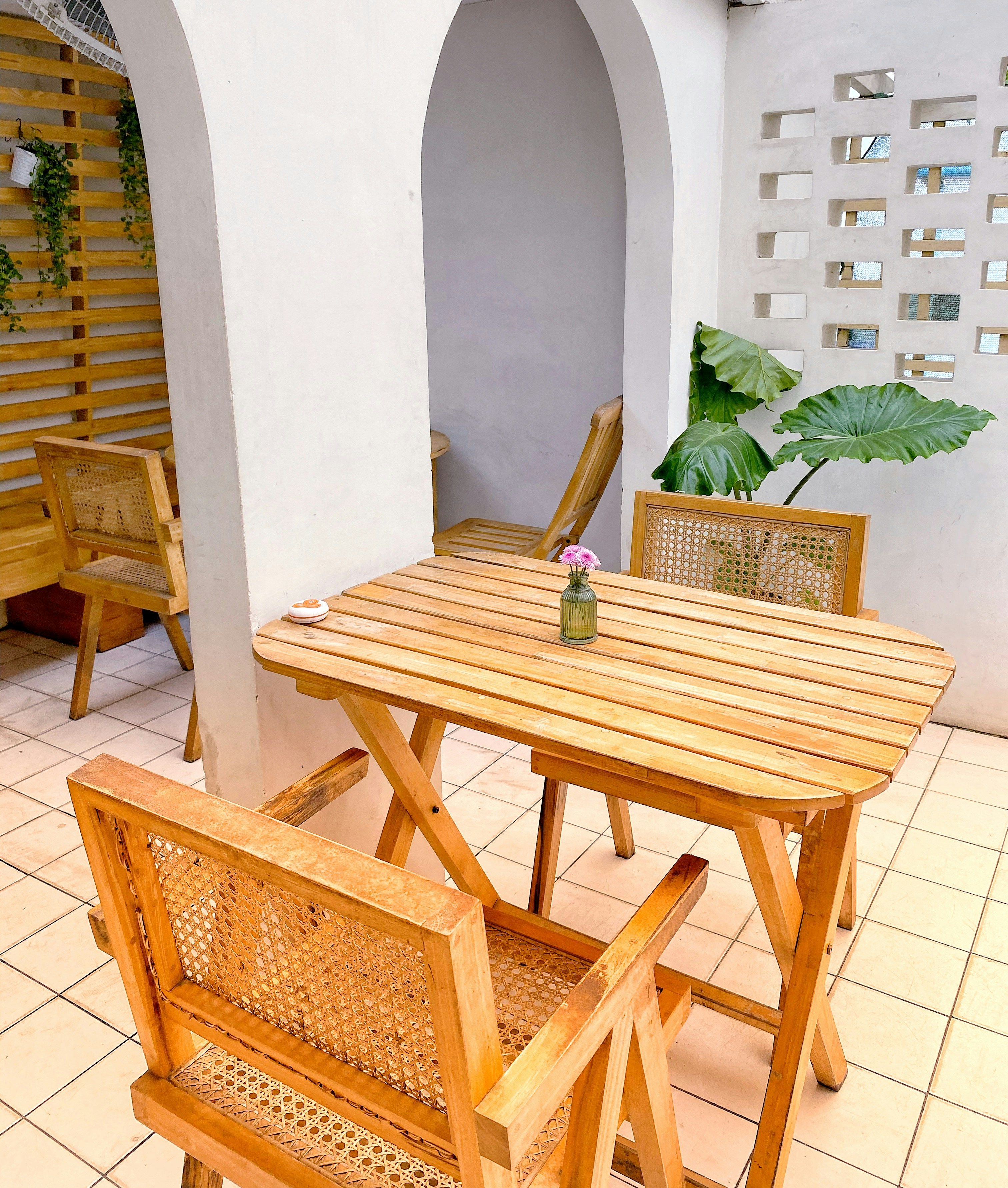 Cozy outdoor cafe seating arrangement is pictured.