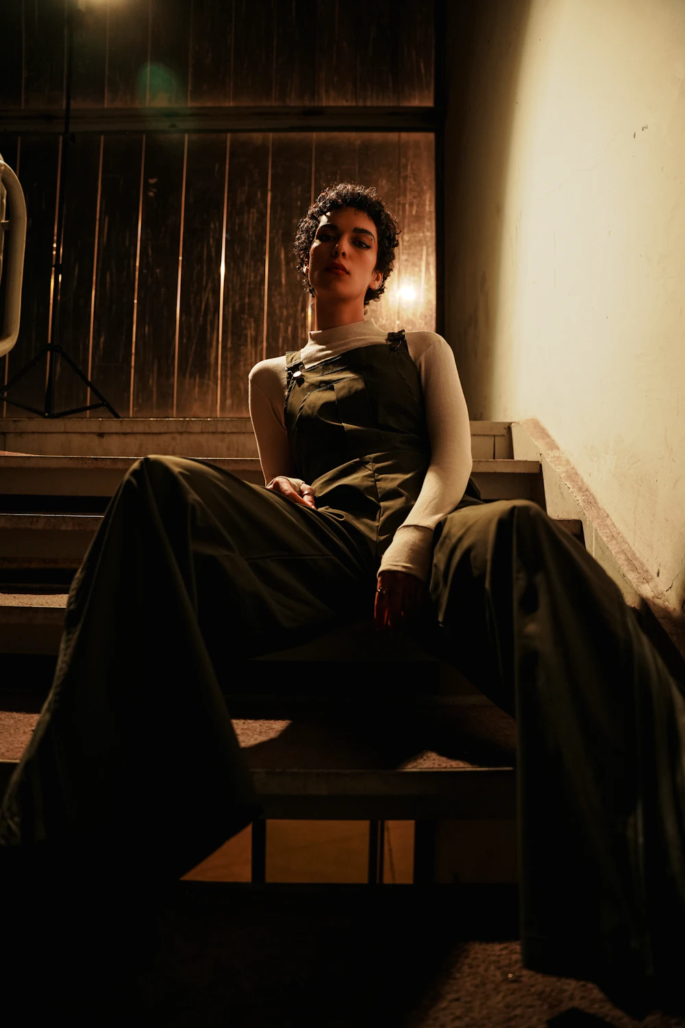 Model posing dramatically on stairs, editorial fashion
