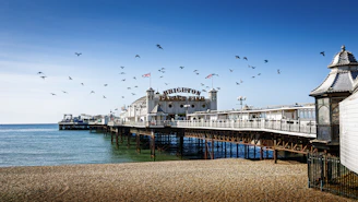 A pier overlooks a beautiful sandy beach.