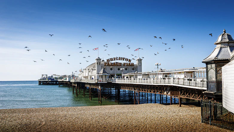 A pier overlooks a beautiful sandy beach.