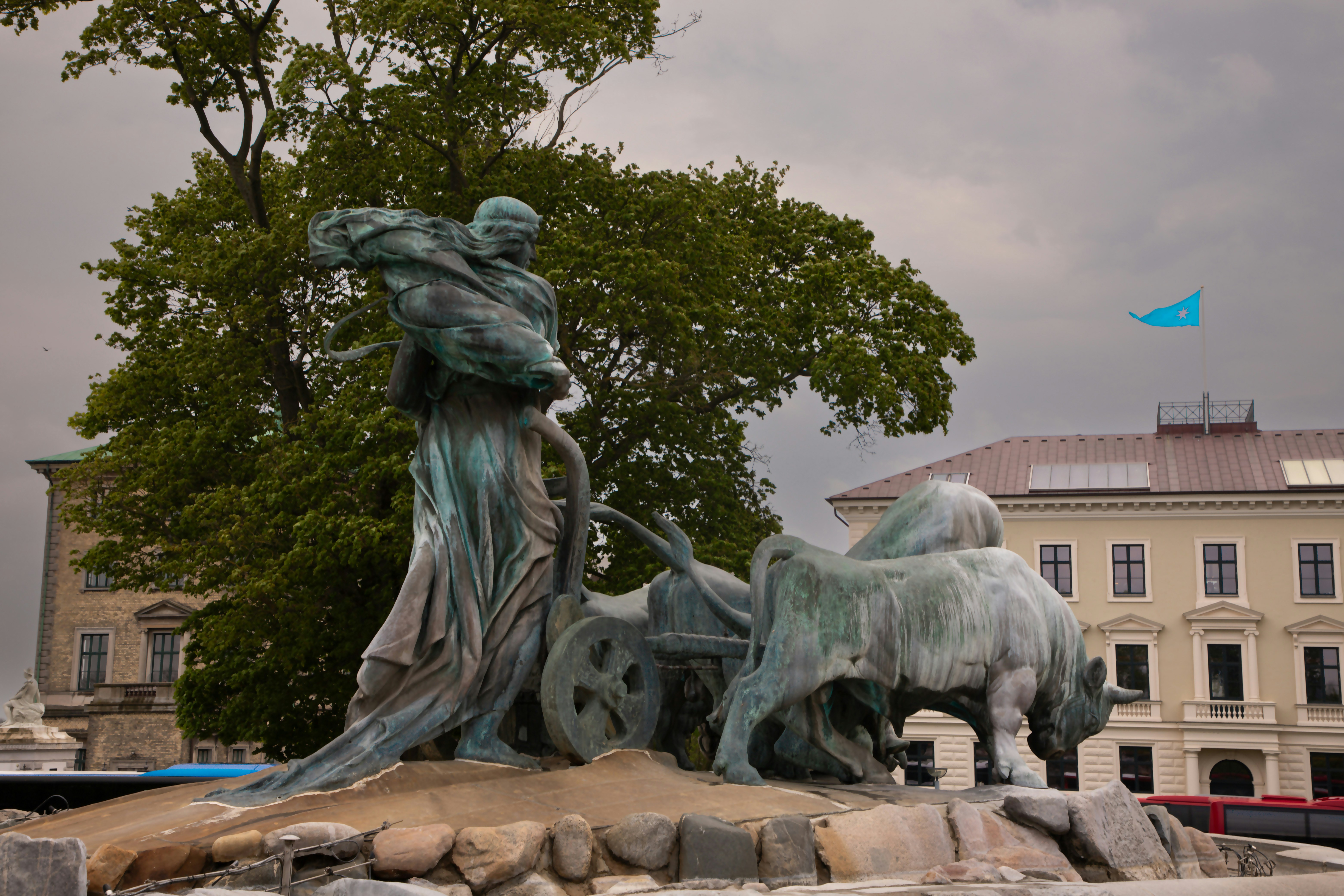 A bronze statue depicts a figure with chariot and oxen.