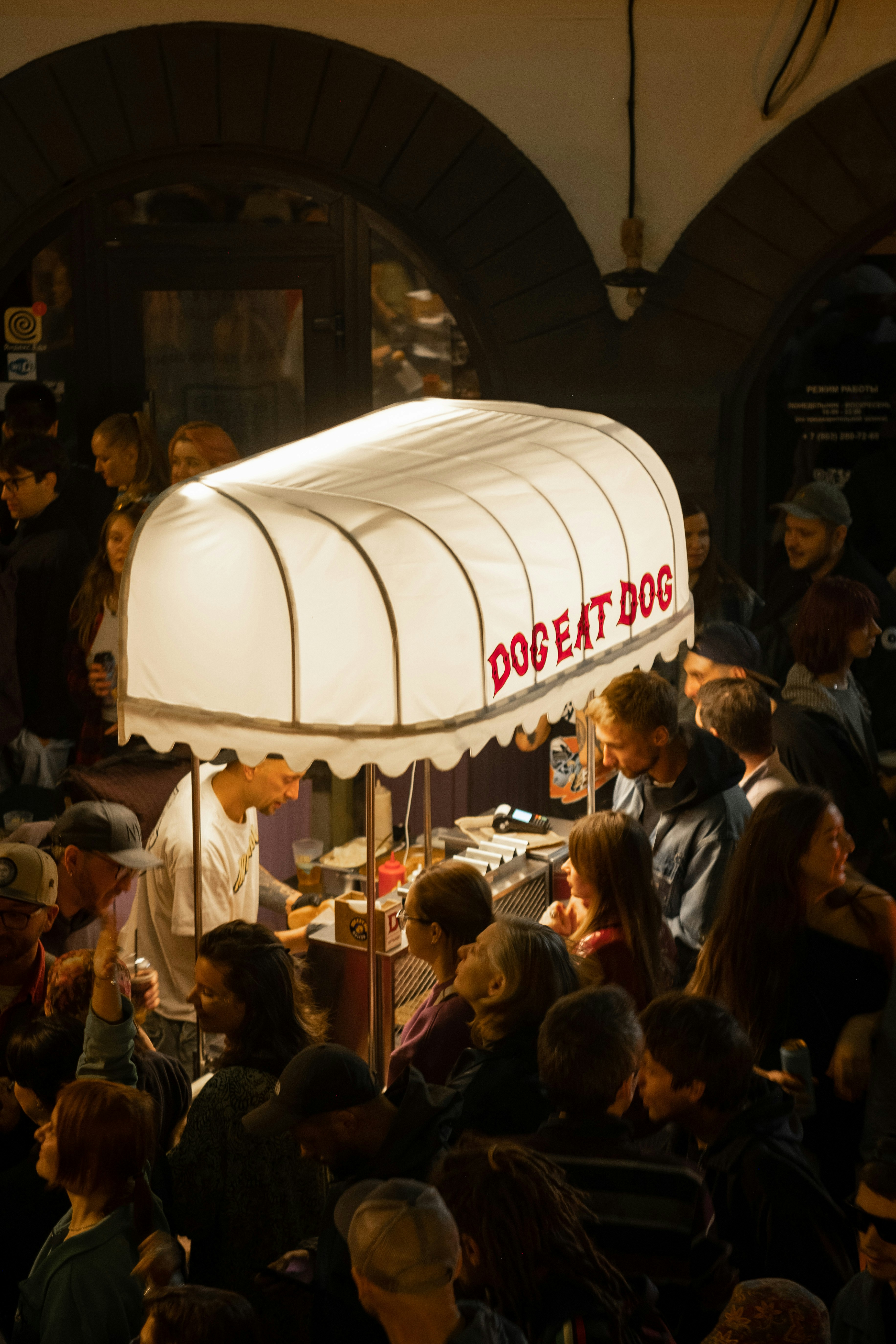 People line up at a "dog eat dog" food cart.