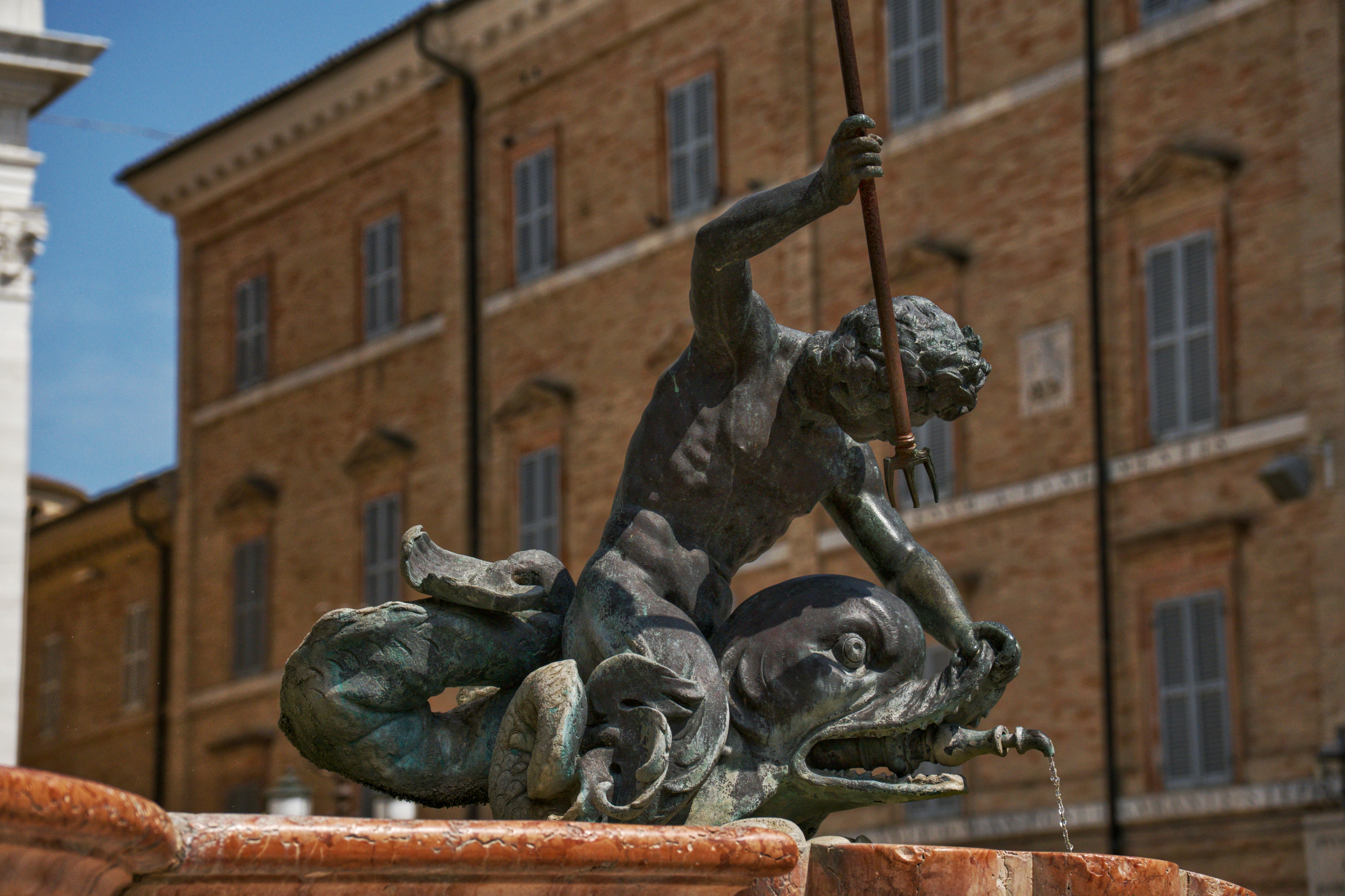 Statue of a man riding a fish.
