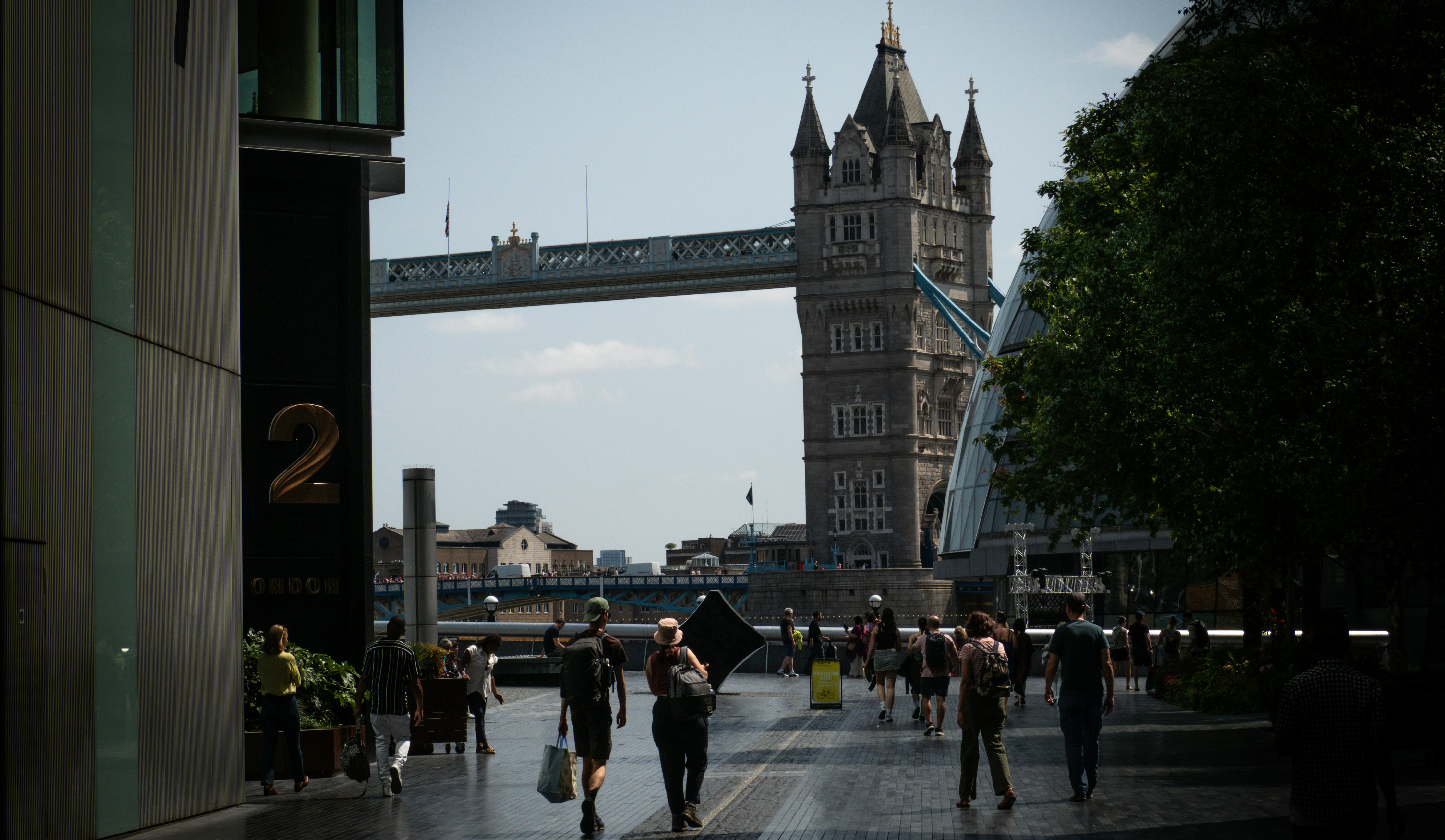 People walk towards tower bridge in london.