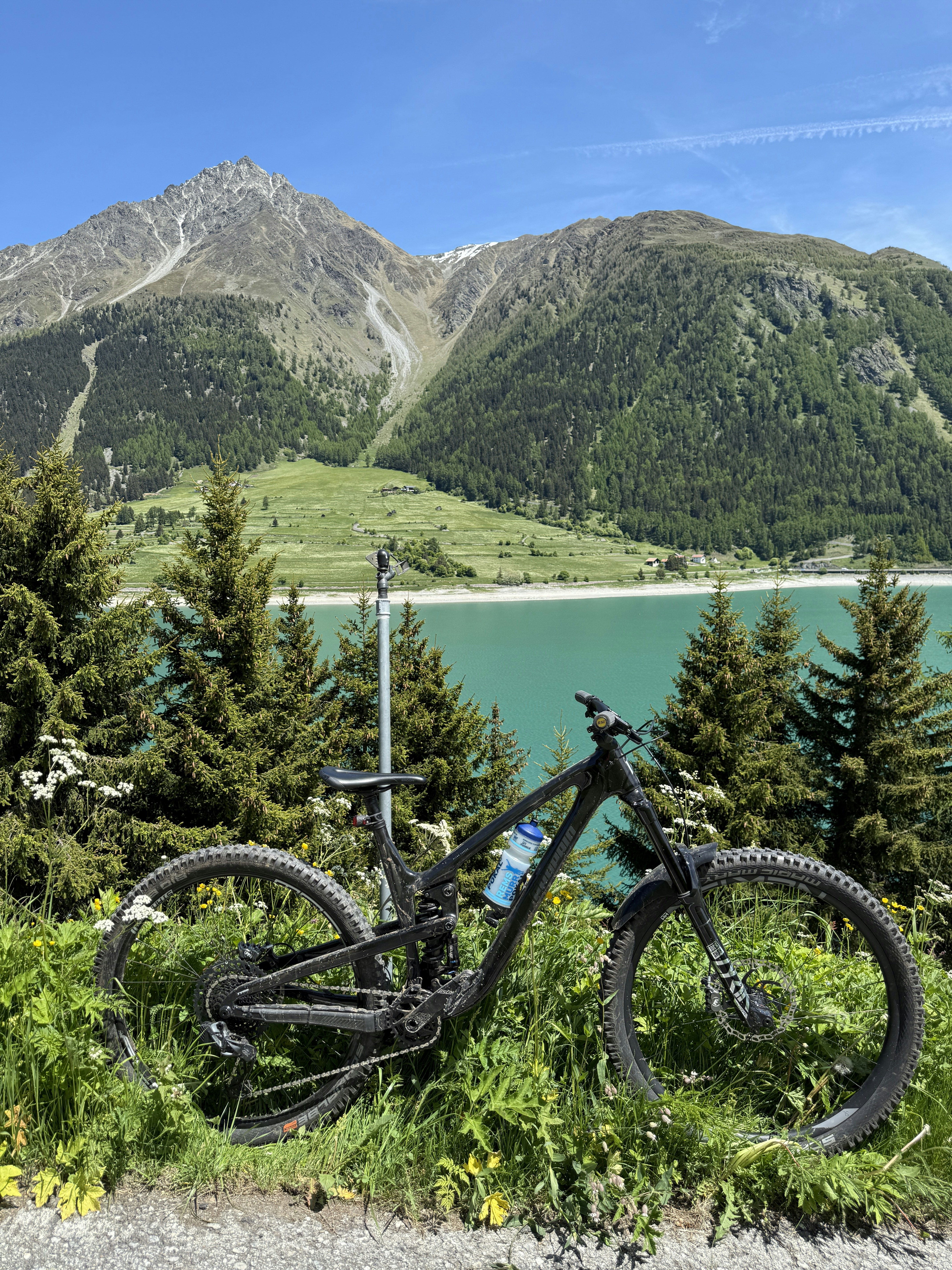 A mountain bike rests before a scenic lake.