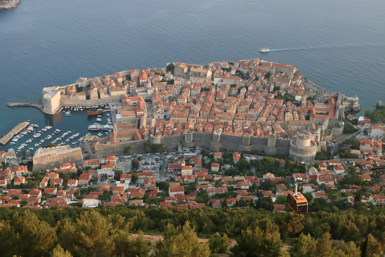 Dubrovnik's walled old town from above at sunset, terracotta roofs over the Adriatic