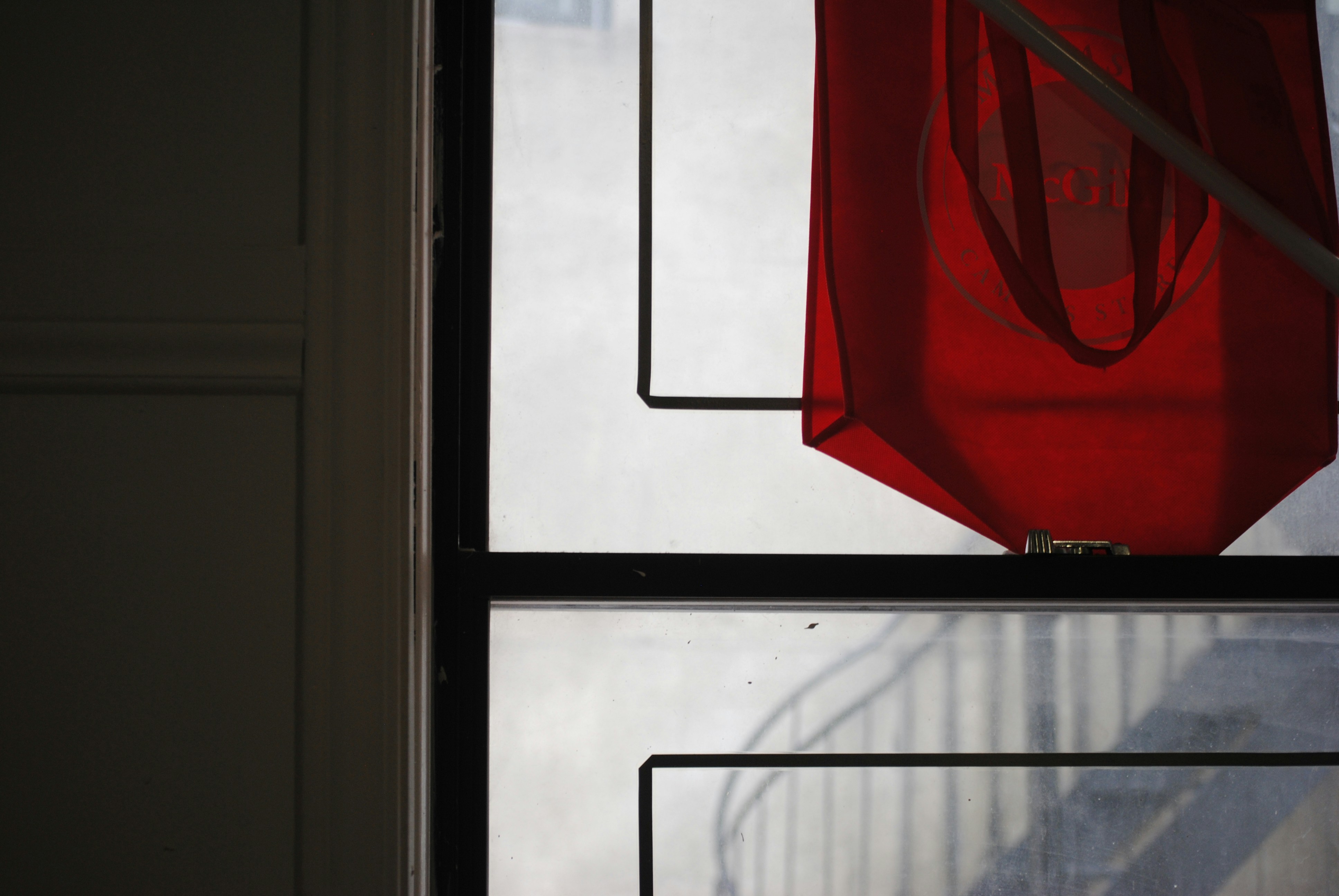 A red cloth hangs near a window.