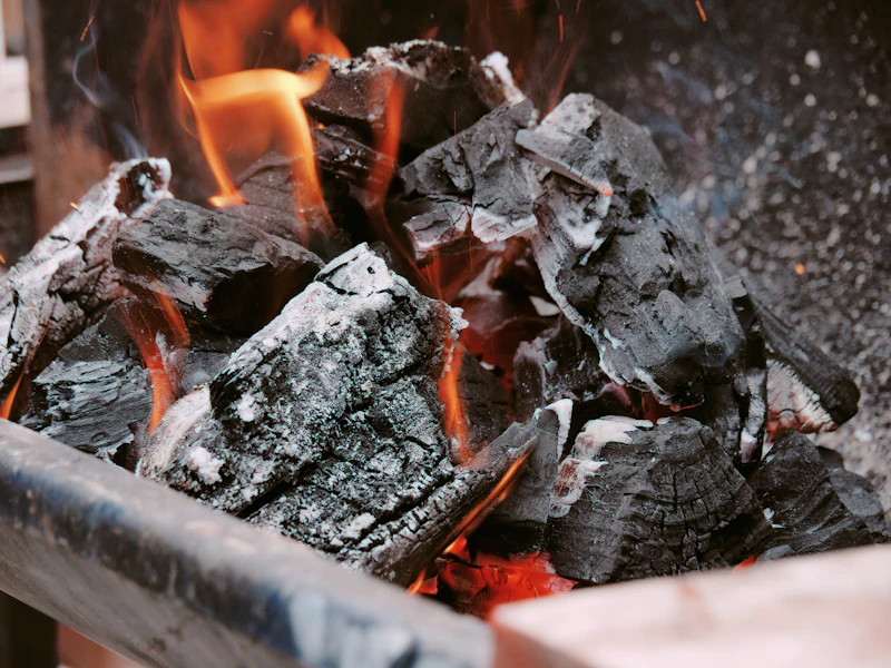 Charcoal fire being lit before service
