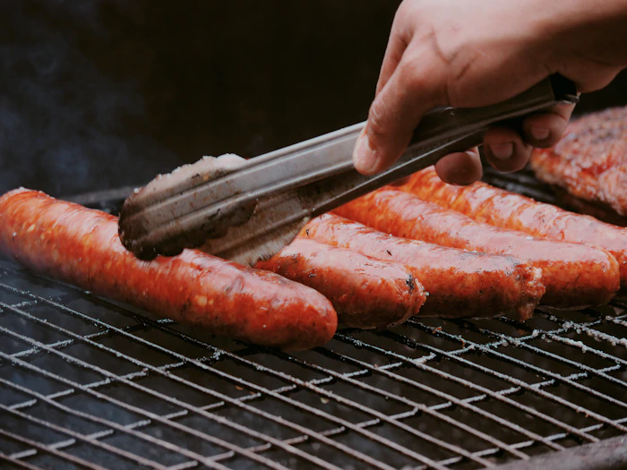 Sausages cooking on a barbecue