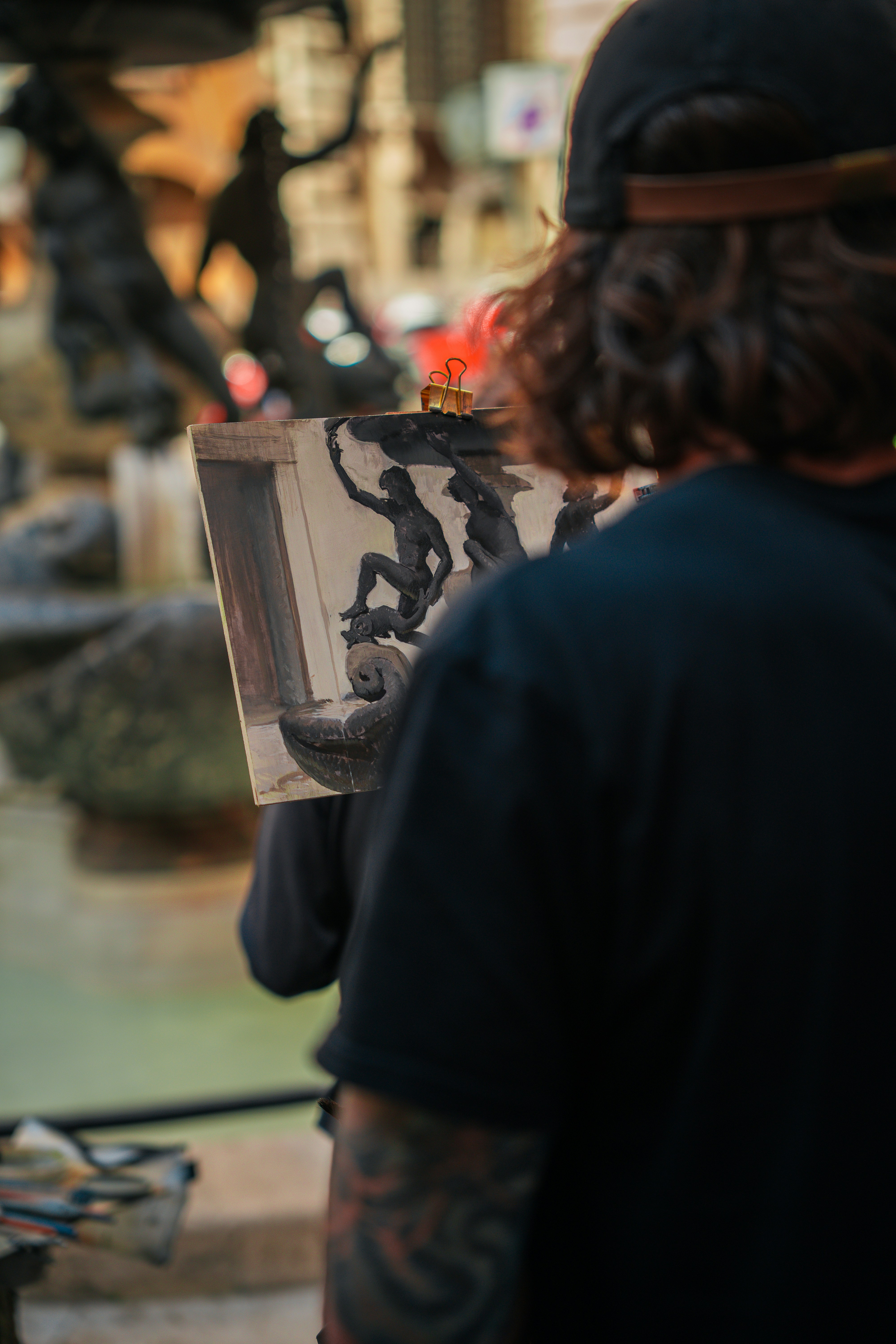 A person is painting a statue in an album.