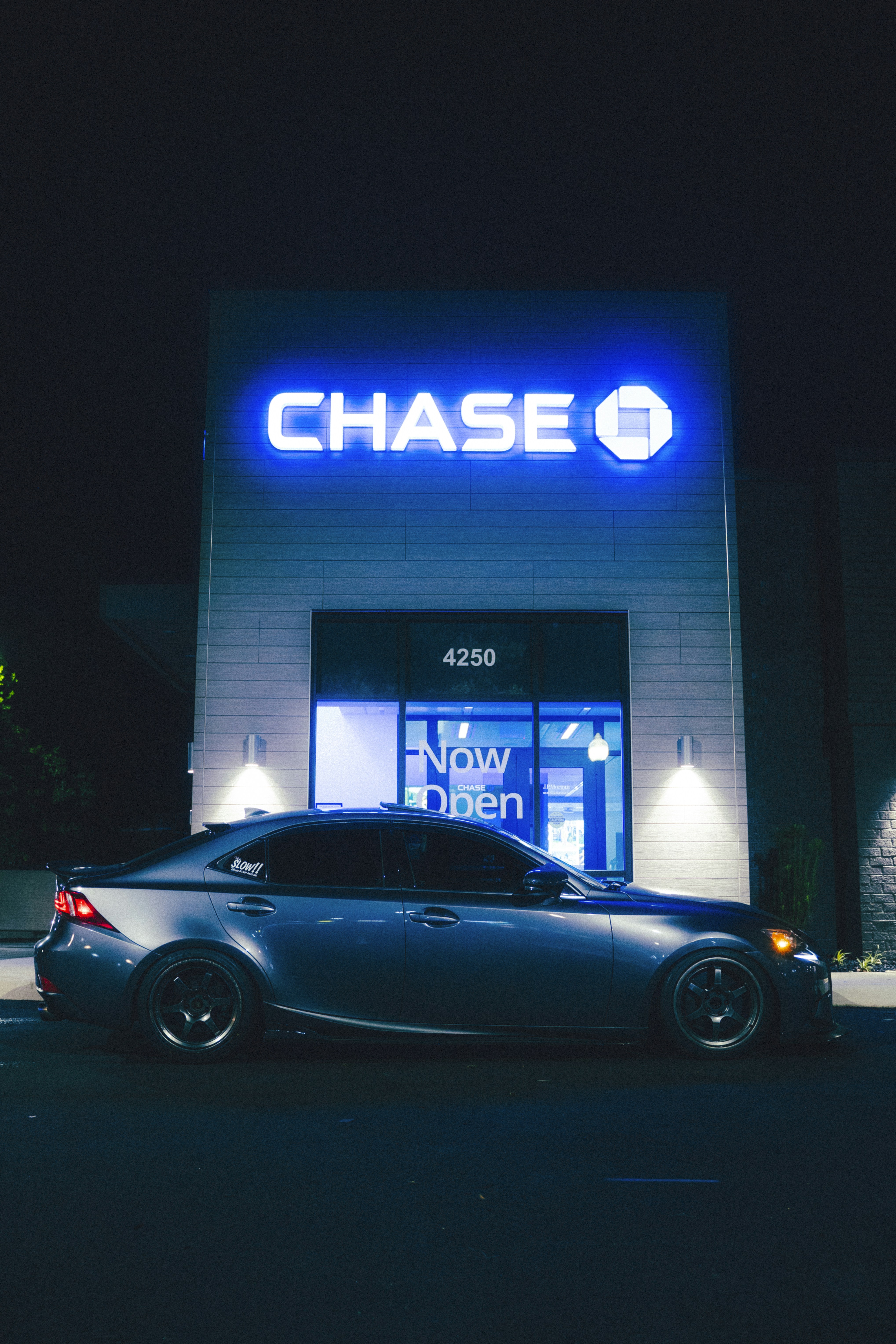 A car is parked in front of a chase bank.