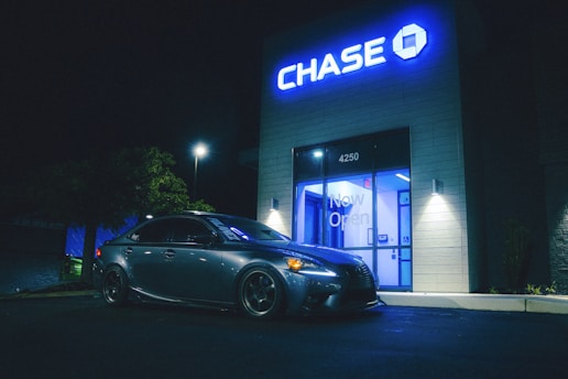 A car parks in front of a chase bank.