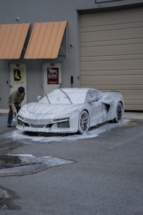 A car is being washed with foam.