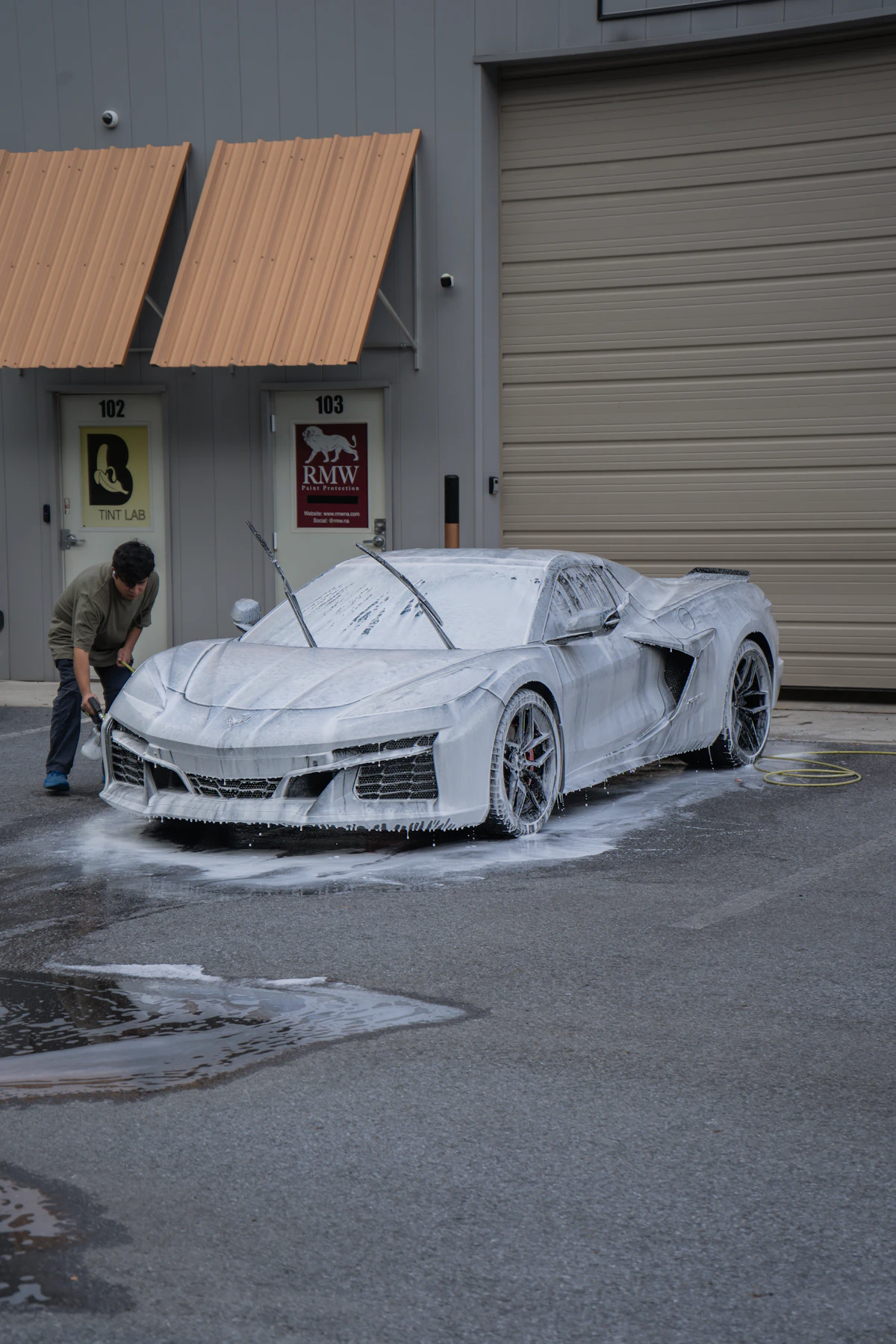 A car being thoroughly washed with foam, representing a fresh mobile detail