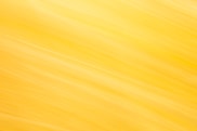 Abstract yellow and white streaks create a bright background.