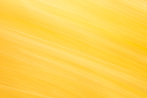Abstract yellow and white streaks create a bright background.