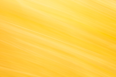 Abstract yellow and white streaks create a bright background.