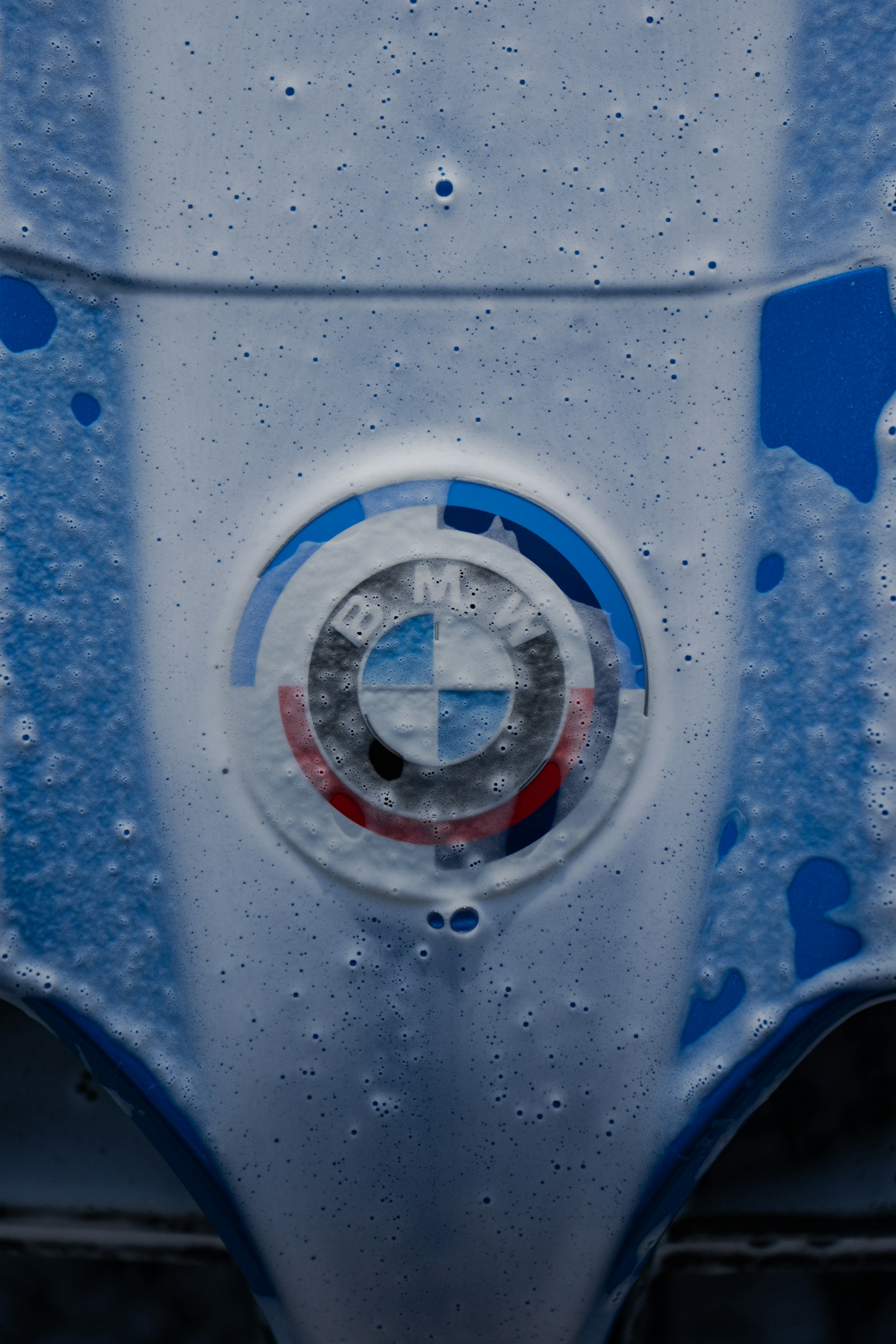 BMW logo covered in soapy foam.