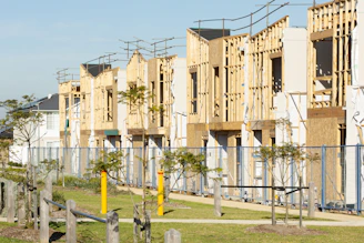 Houses are under construction; framing is visible.