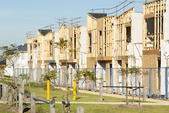 Houses are under construction; framing is visible.