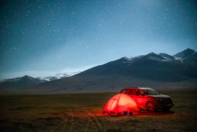 Camping under the stars, a car and tent.