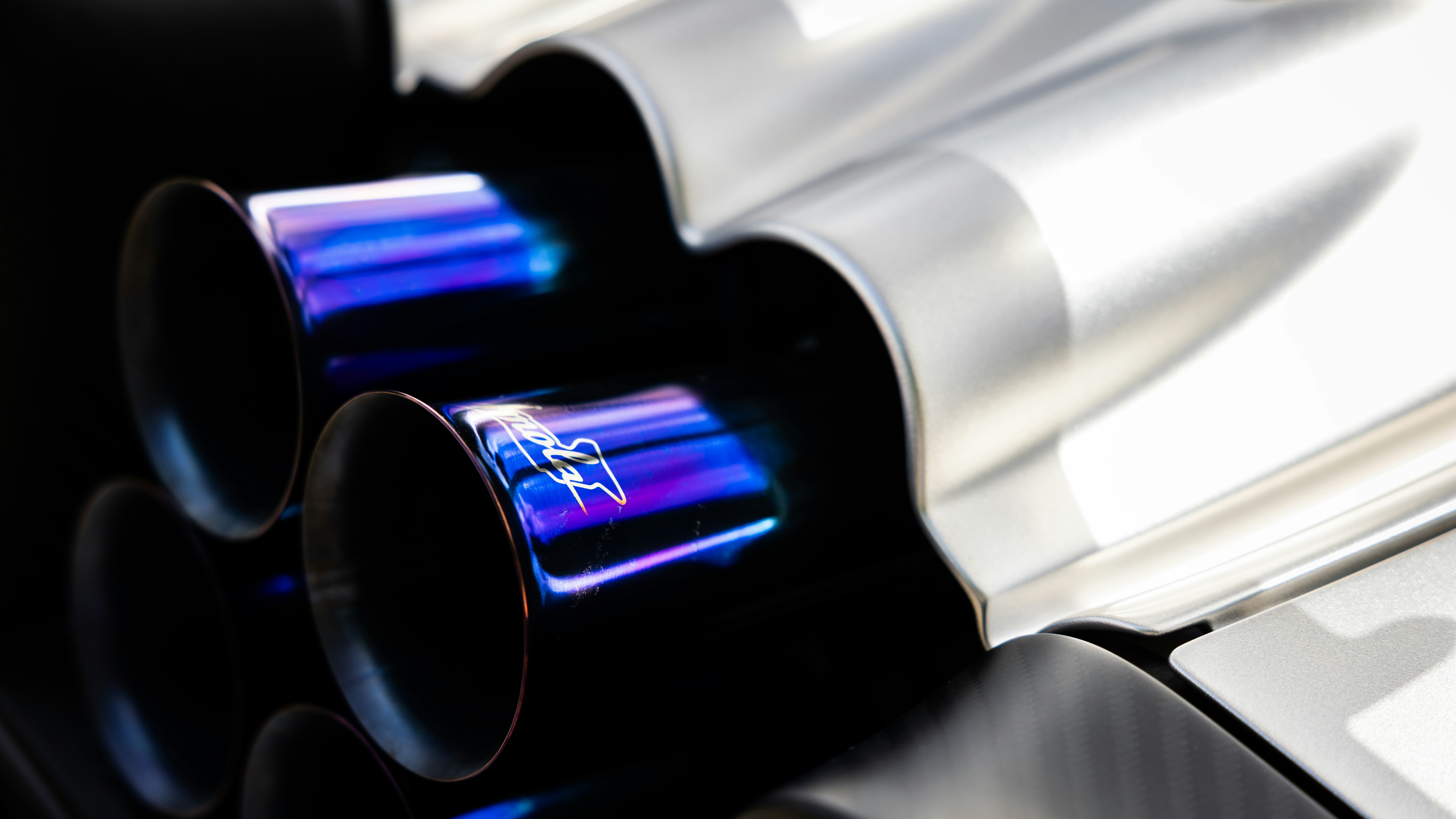 Blue exhaust pipes of a vehicle are shown.