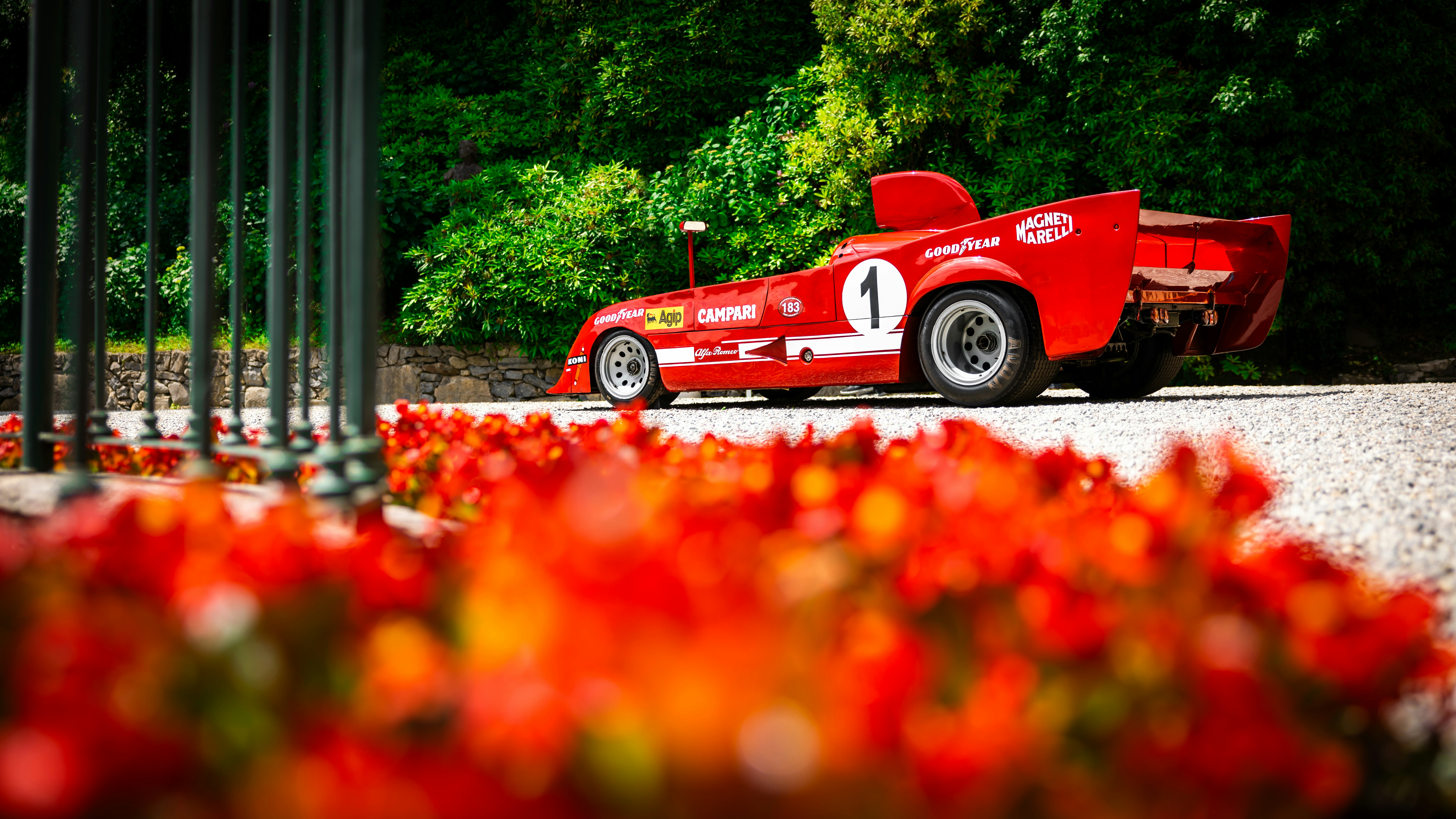 A classic red race car on display.