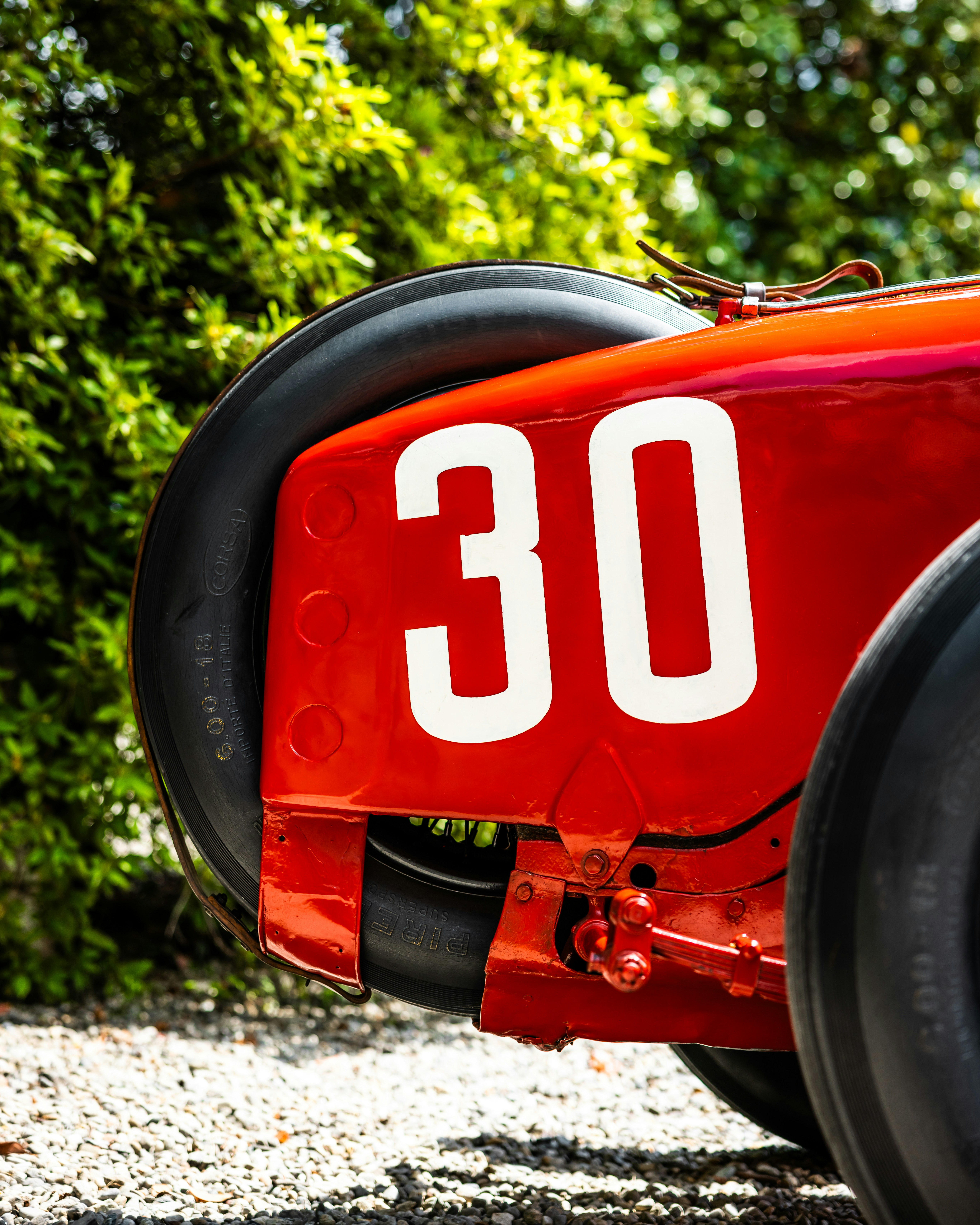 A red vintage race car with number 30.