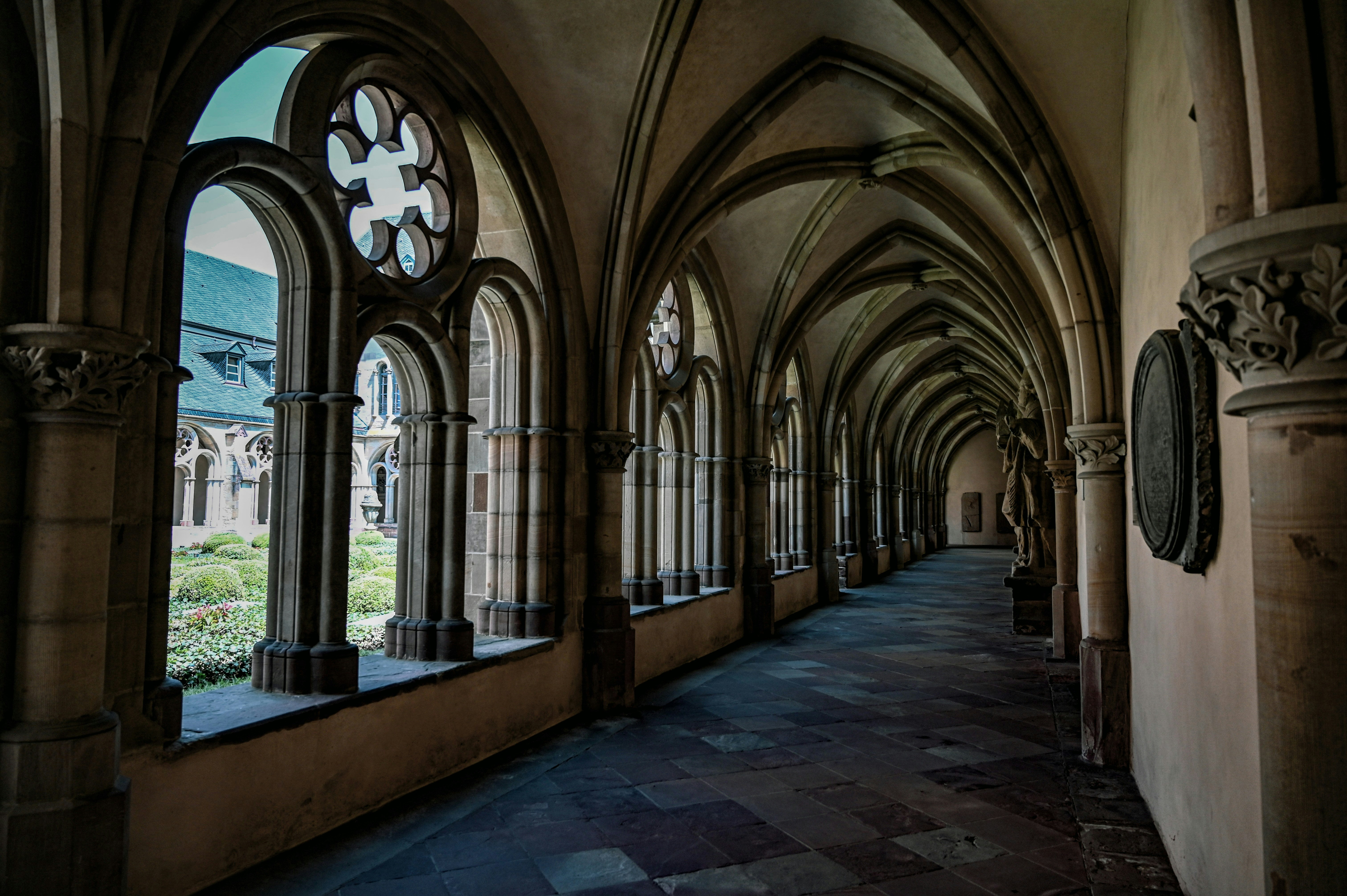 An arched hallway with ornate windows.
