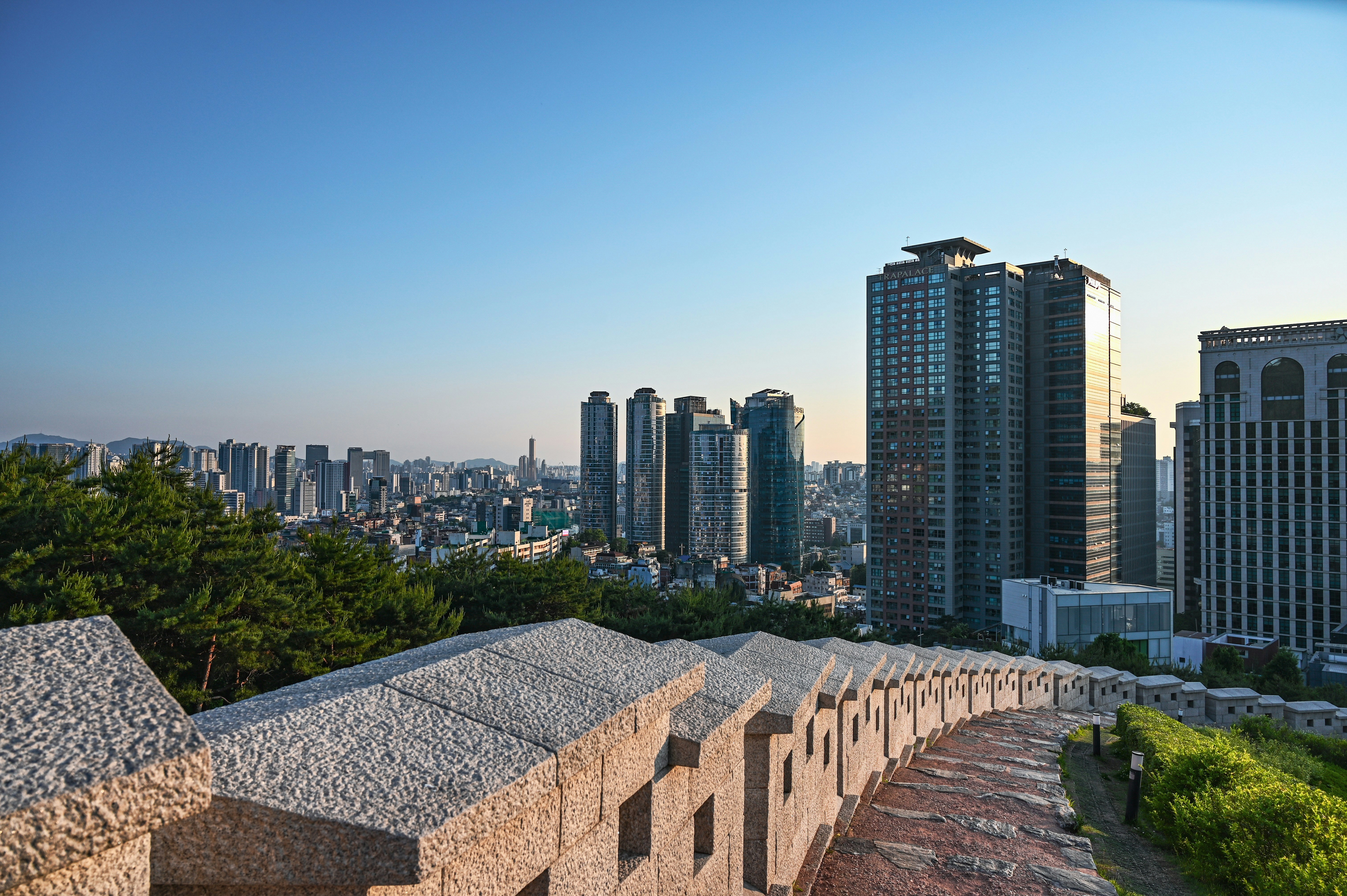Cityscape with modern buildings under a blue sky.