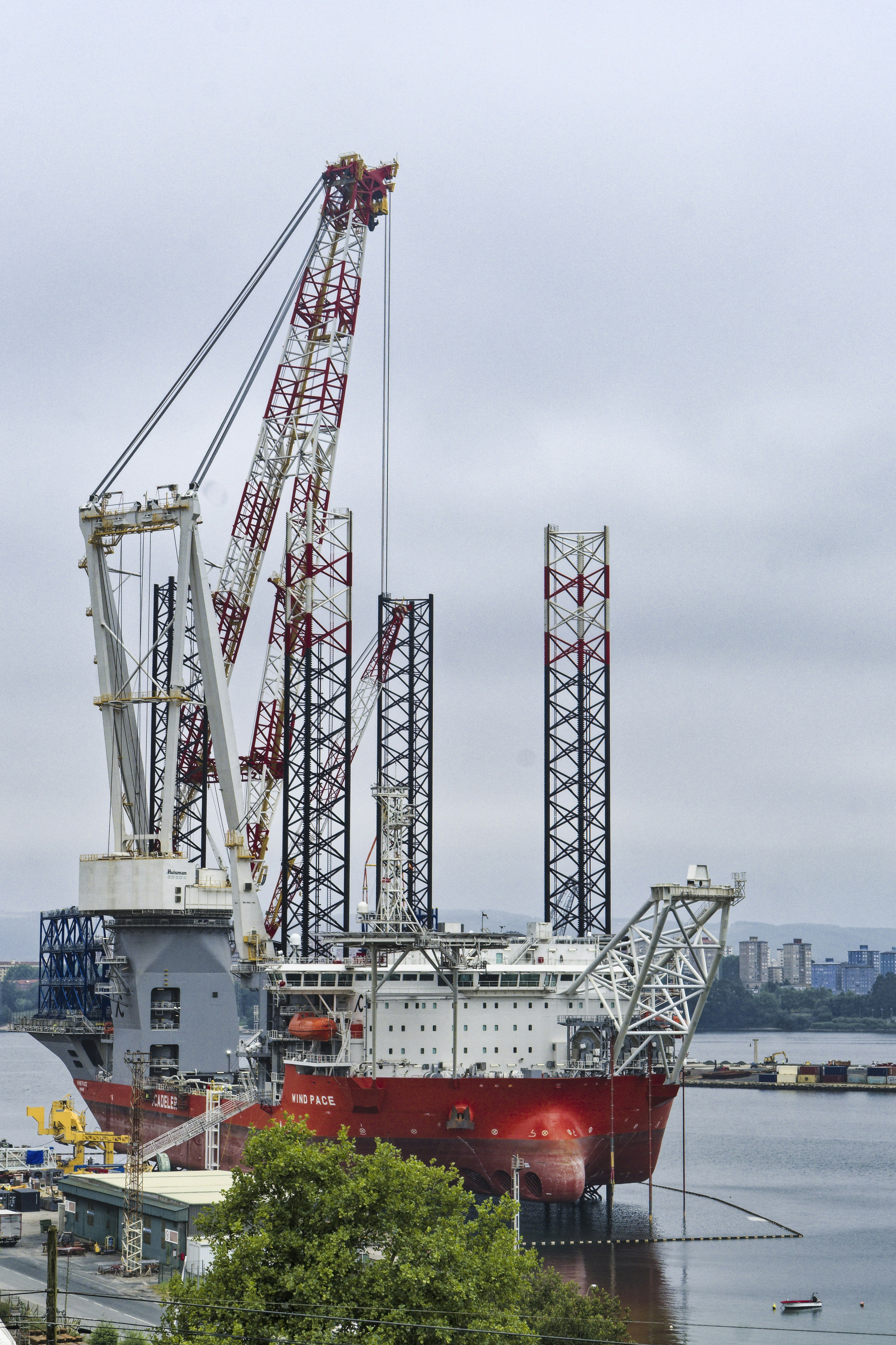 A large crane ship is parked at the dock.
