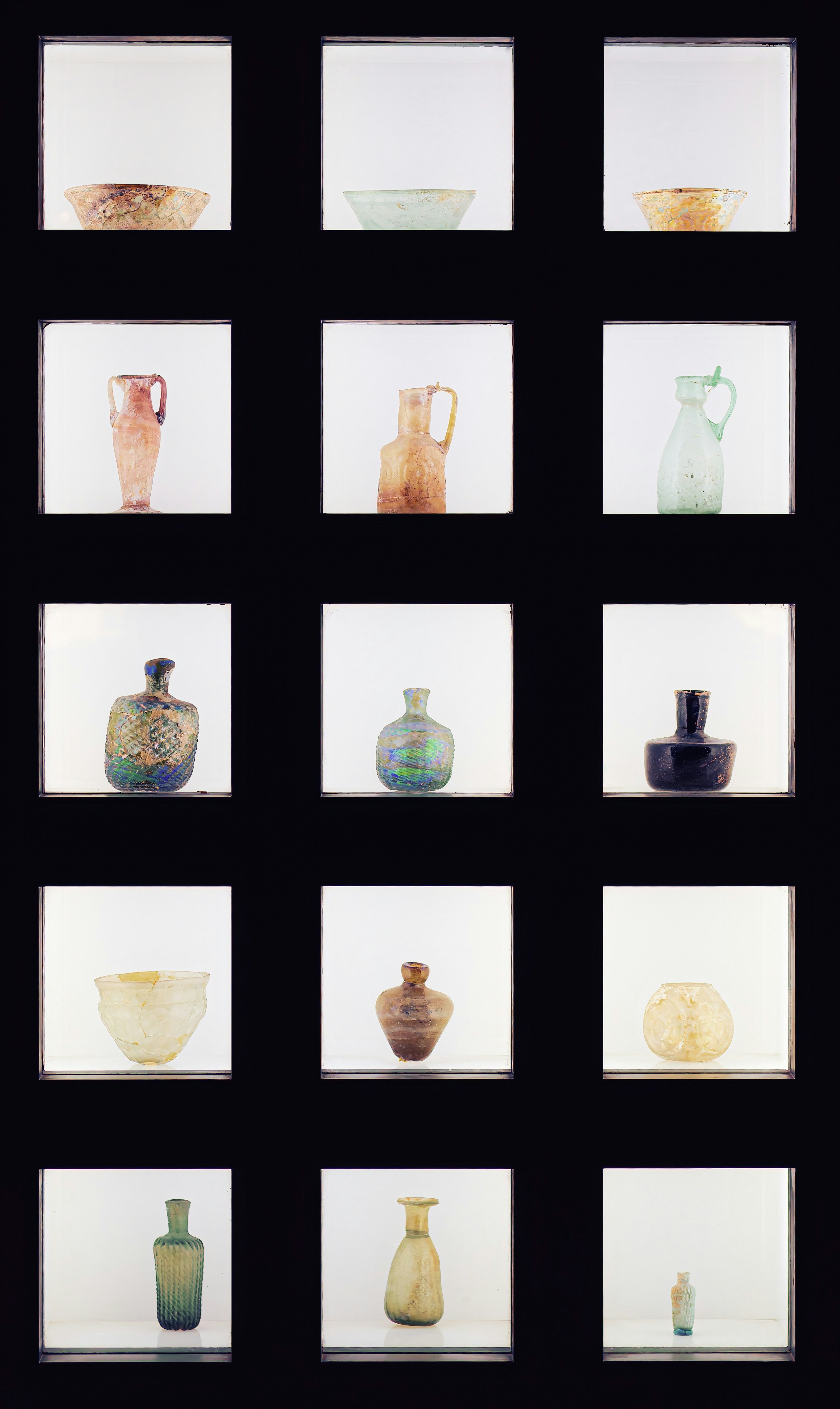 Various pottery items are displayed in illuminated squares.