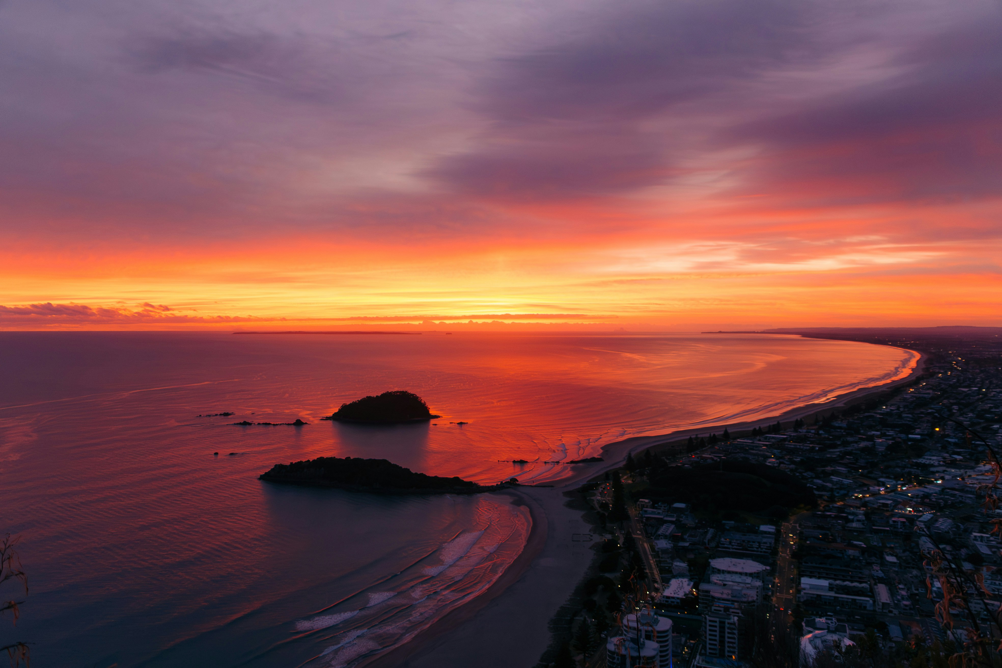 Vibrant sunset glows over the coastline.