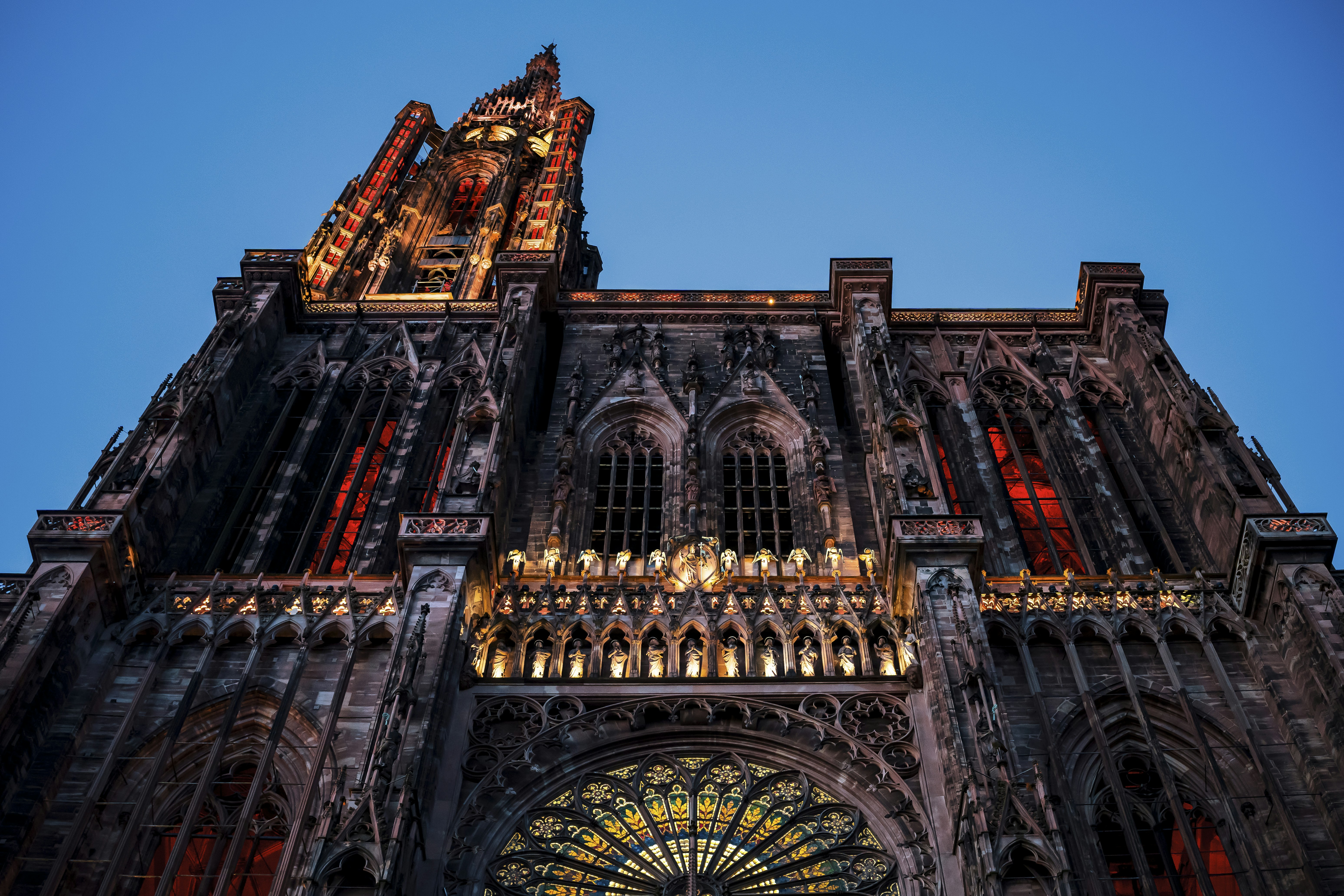 Gothic cathedral facade illuminated at twilight.