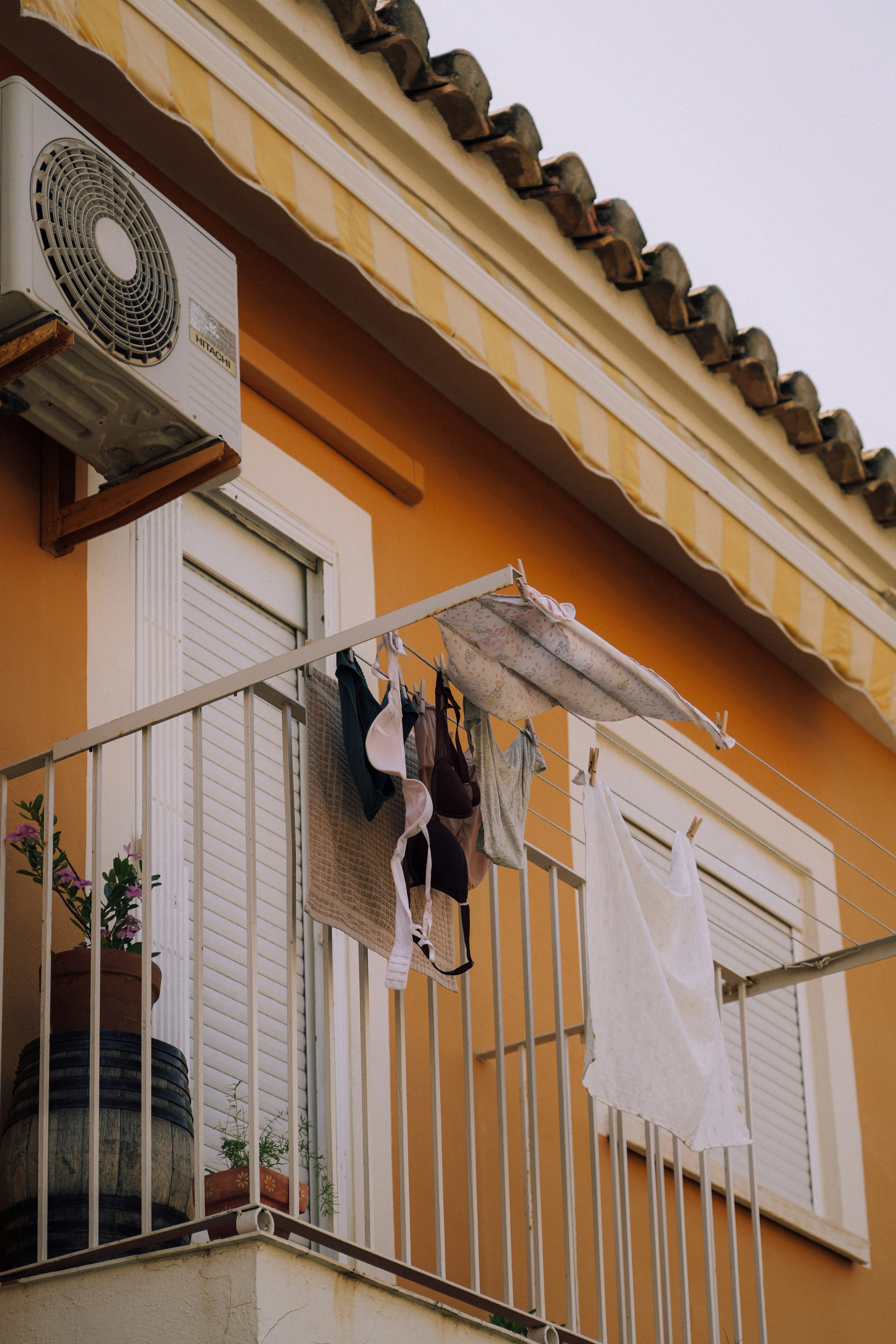 Laundry hangs to dry on a balcony.