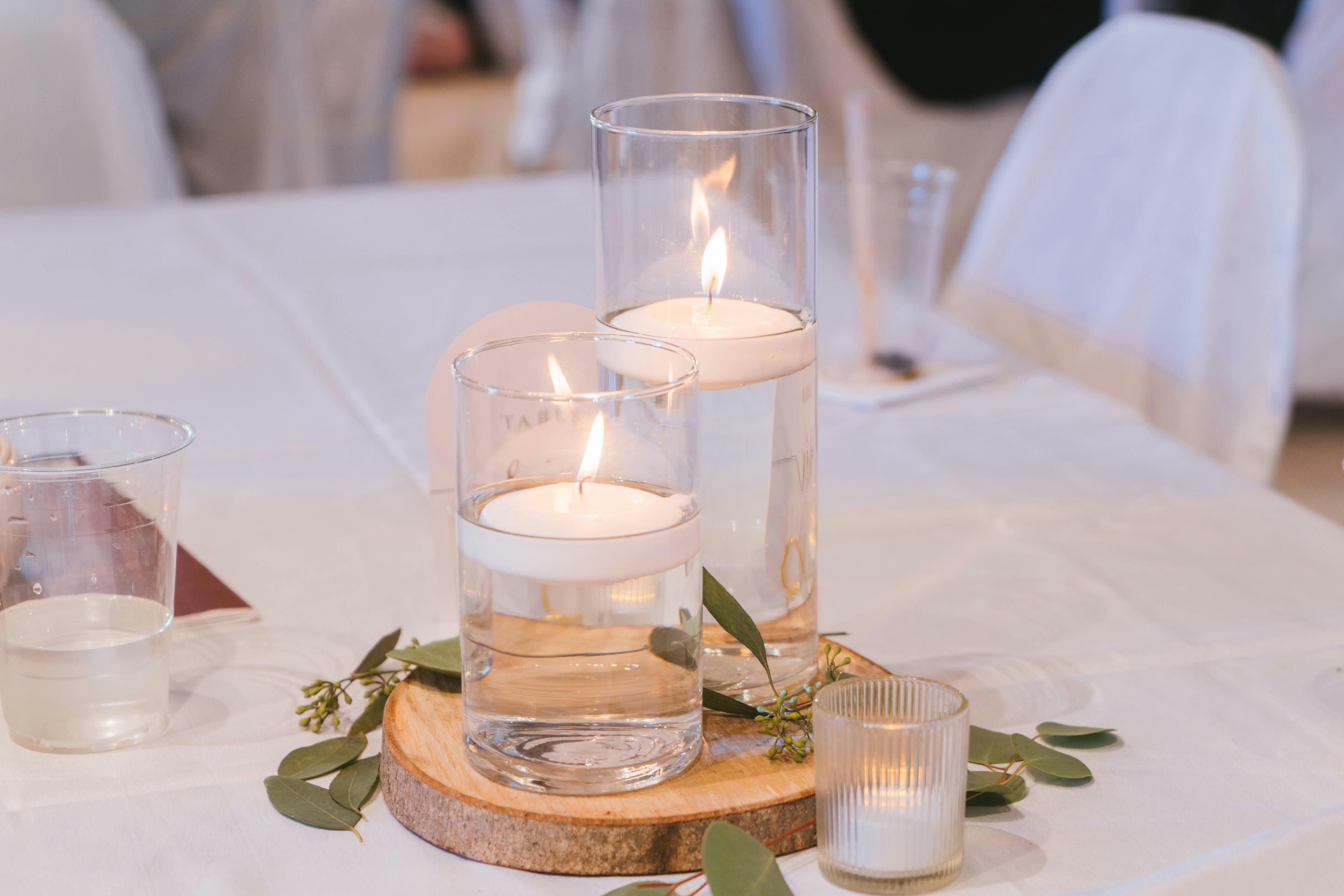 Candles float in water for a romantic centerpiece.