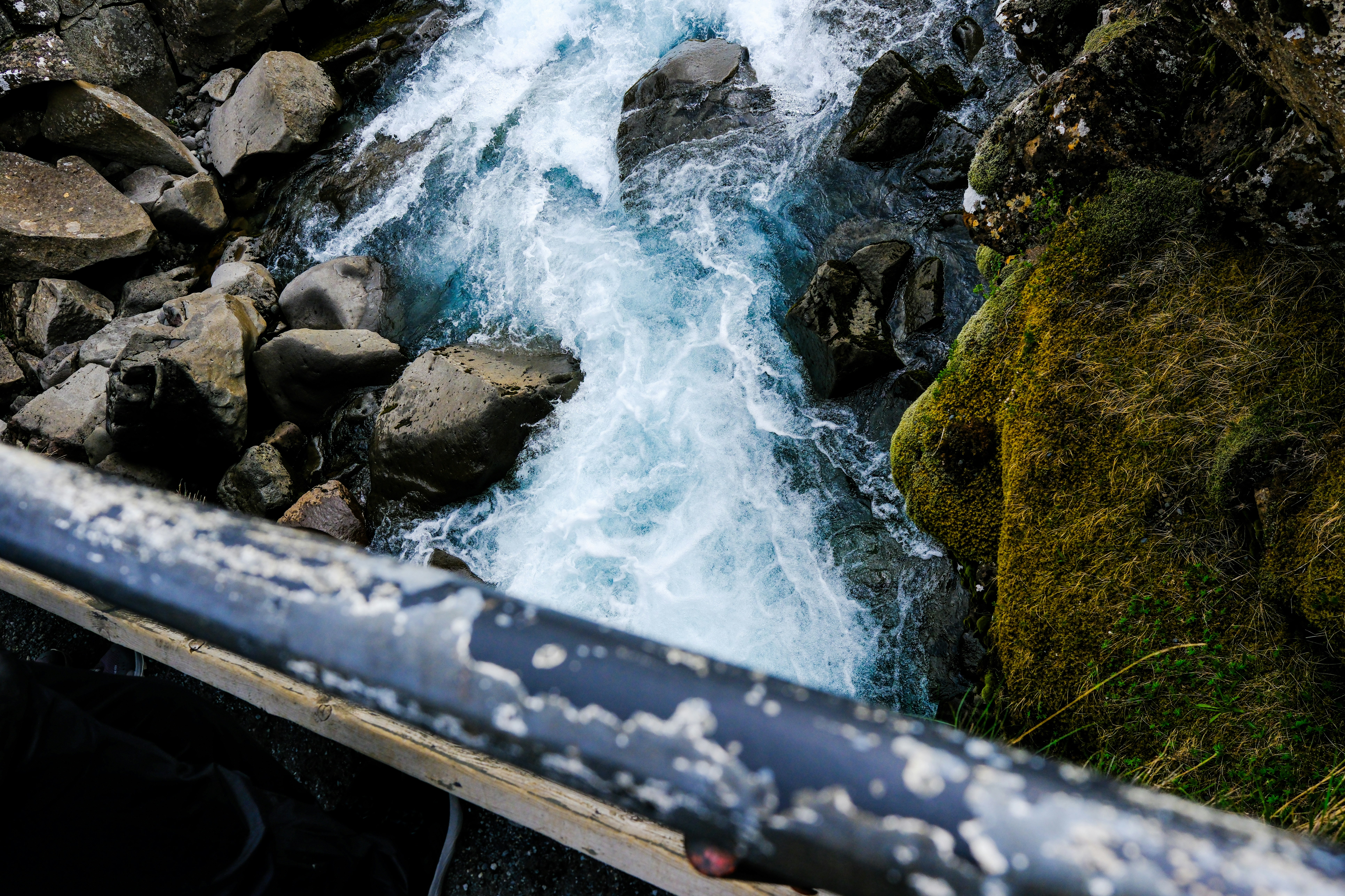 Rushing water cascades through rocks in nature.