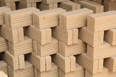 Here's a caption: stacked bricks ready for construction.