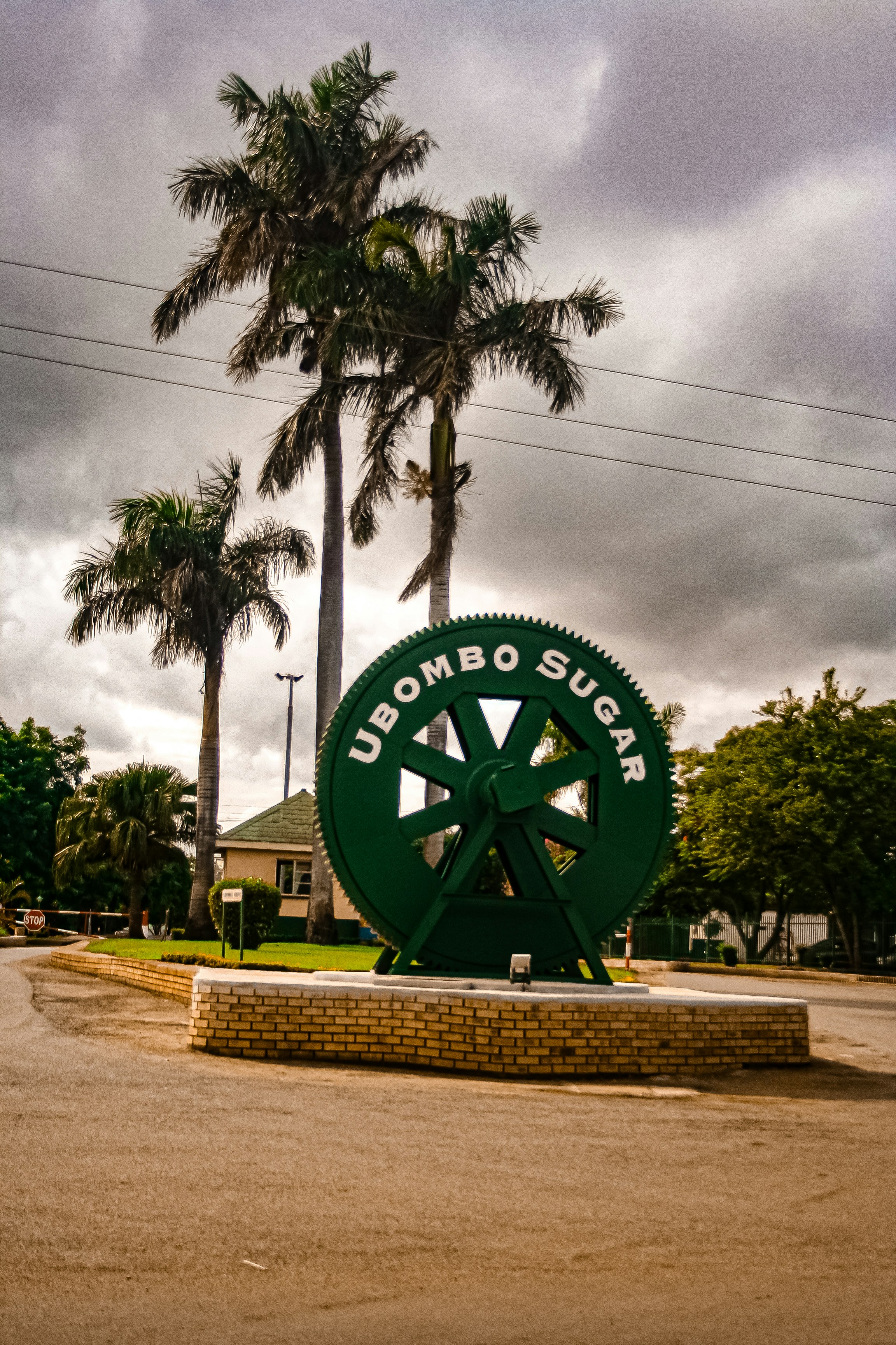Ubombo sugar sign stands with palm trees.