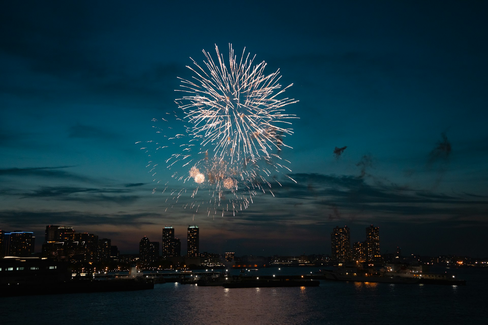 Fireworks light up the night sky over the city.