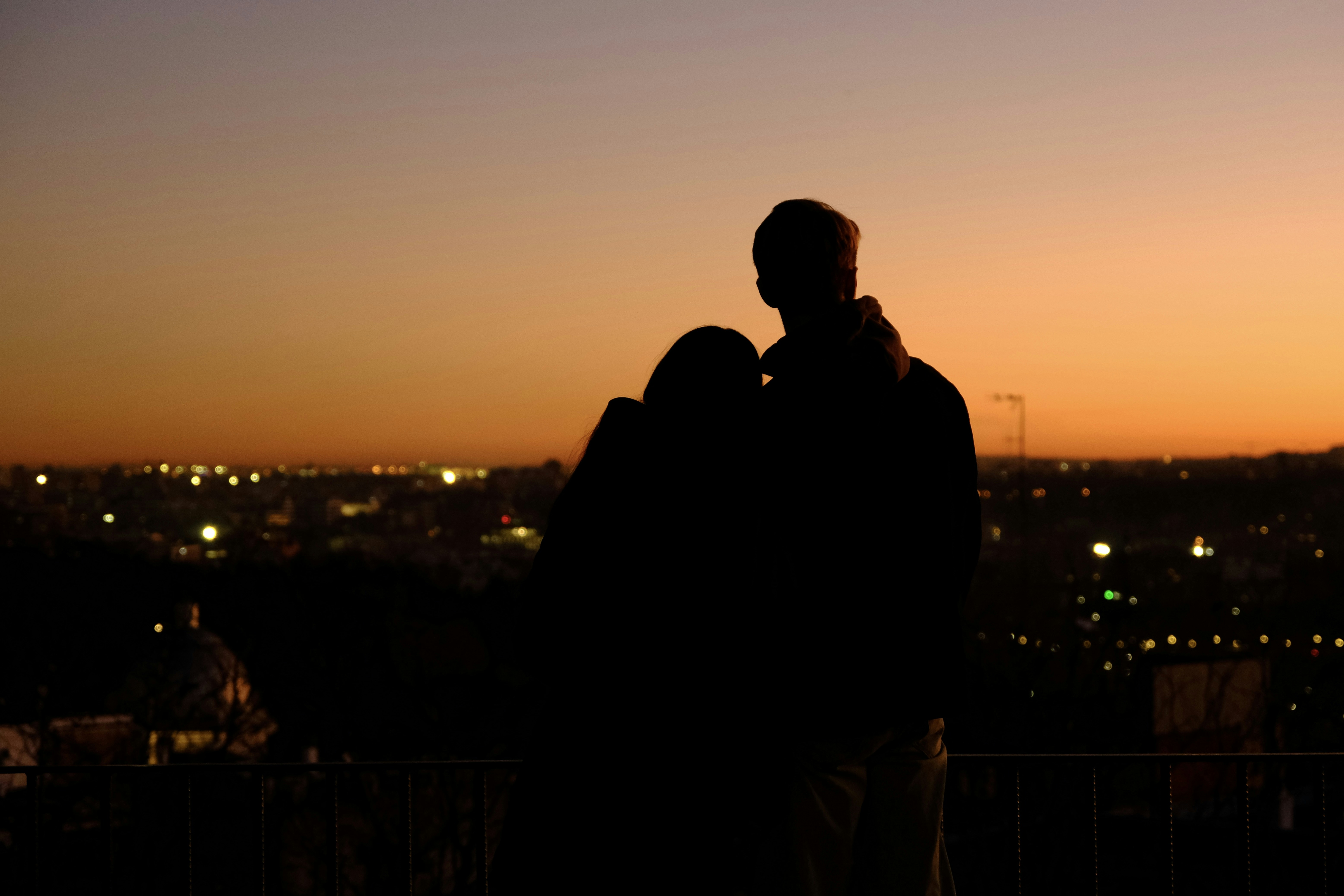 couple enjoying the view from their apartment balcony at sunset - streeterville 2 bedroom apartments