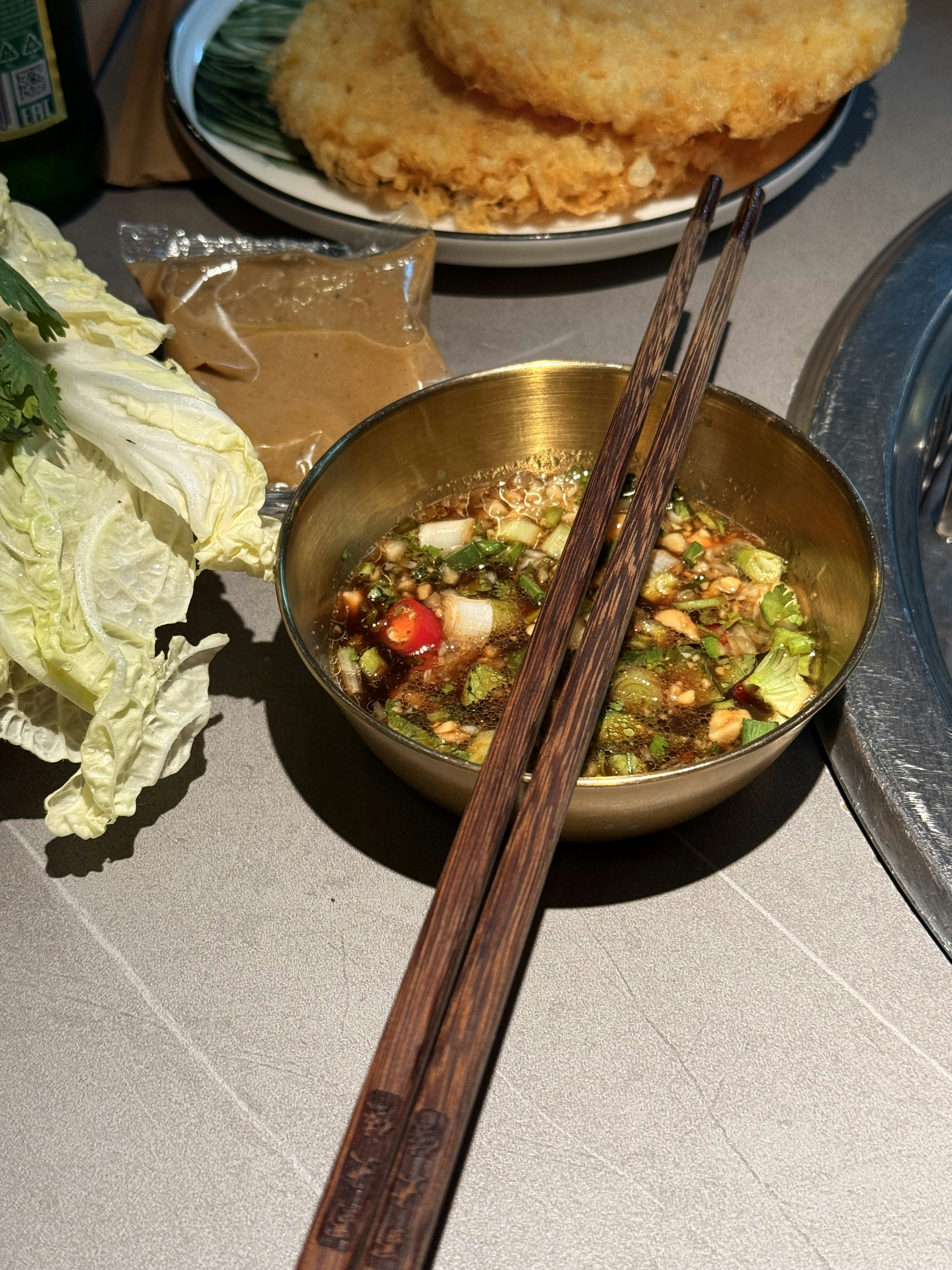 Delicious dipping sauce with appetizers and greens.