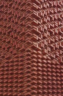 Red brick wall with a unique, layered design.